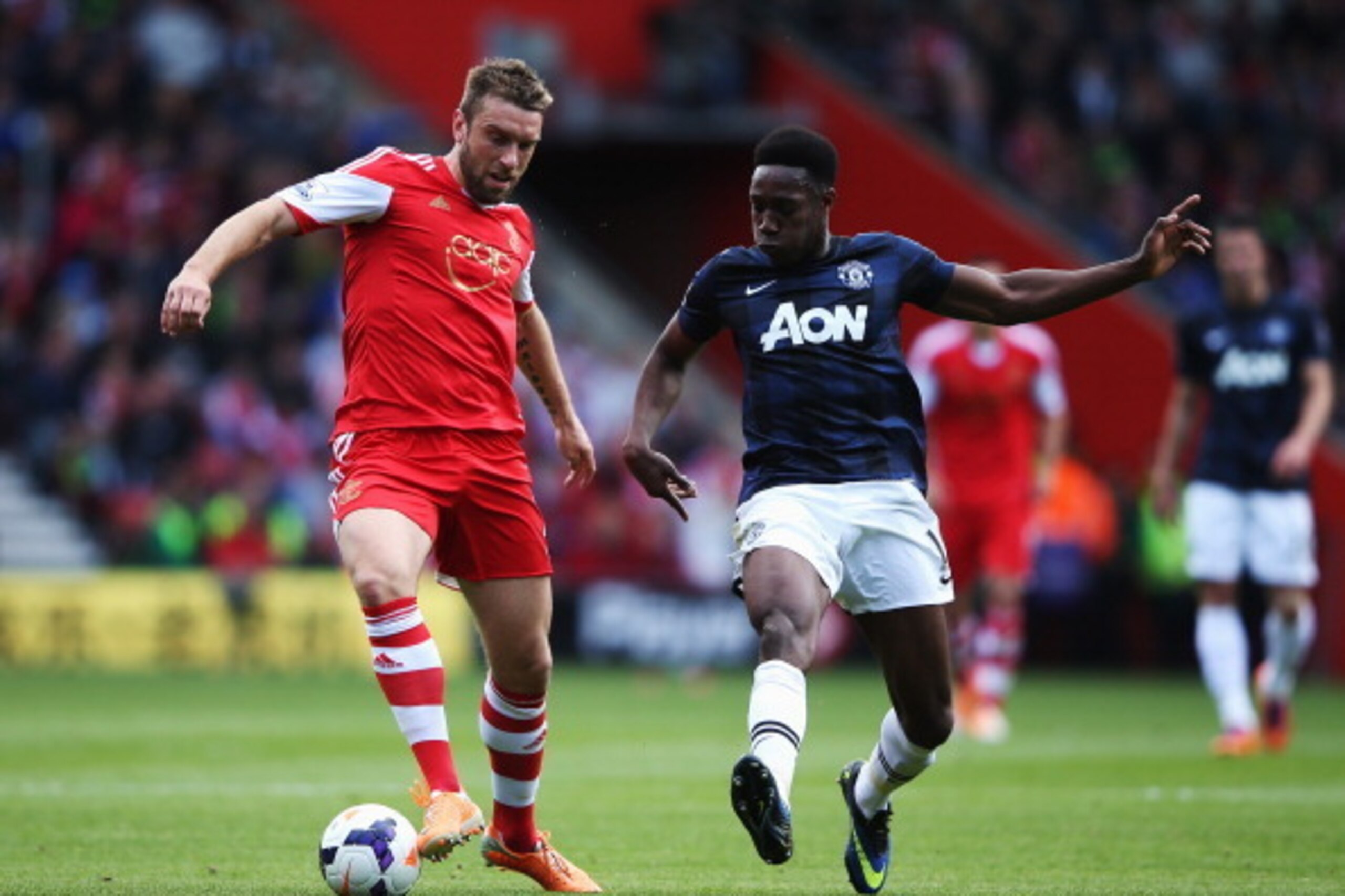 SOUTHAMPTON, ENGLAND - MAY 11:  (L-R) Rickie Lambert of Southampton holds off Danny Welbeck of Manchester United during the Barclays Premier League match between Southampton and Manchester United at St Mary's Stadium on May 11, 2014 in Southampton, Englan