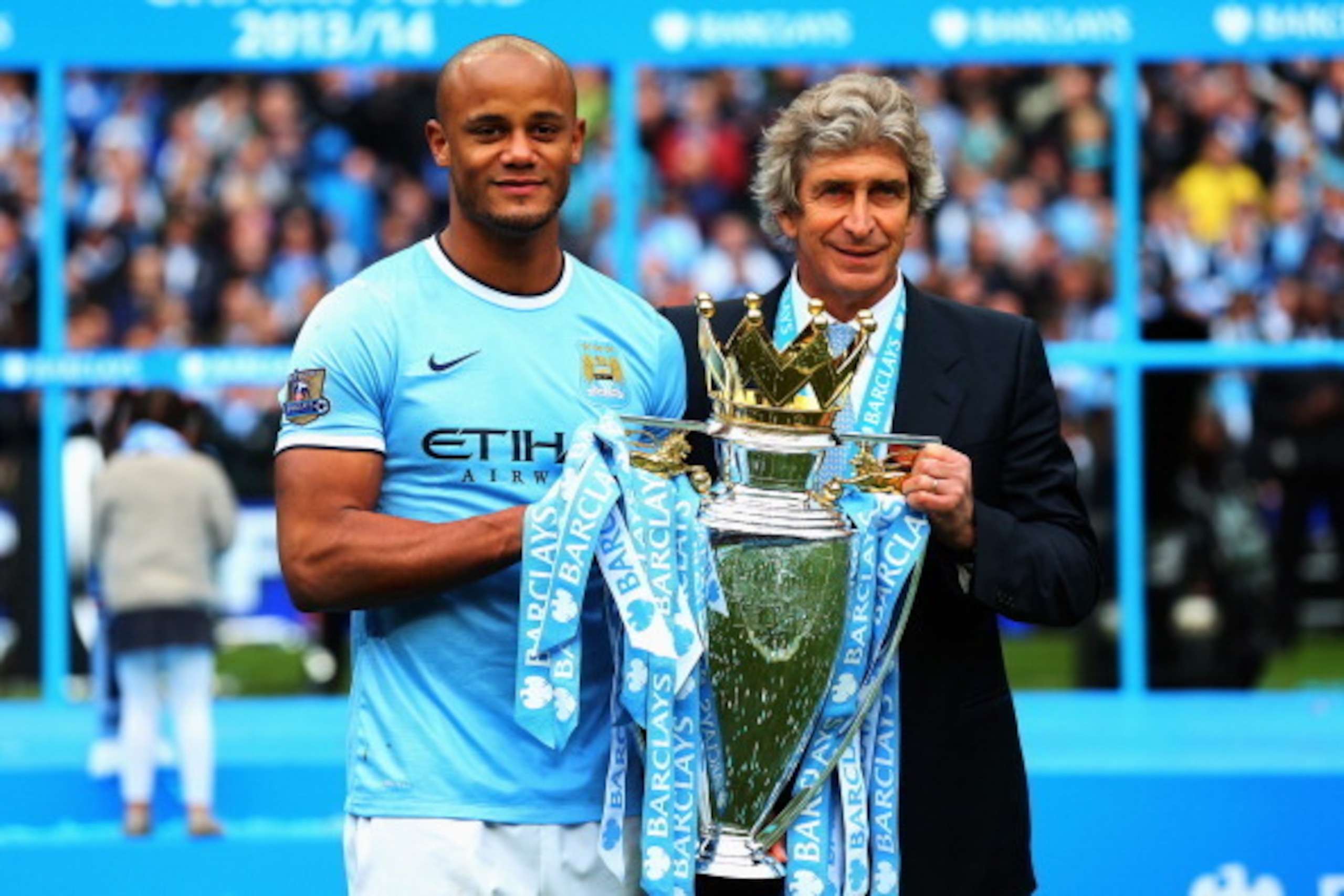 MANCHESTER, ENGLAND - MAY 11: Vincent Kompany (L) of Manchester City poses with manager Manuel Pellegrini and the Barclays Premier League trophy after the Barclays Premier League match between Manchester City and West Ham United at Etihad Stadium on May 1 MANCHESTER, ENGLAND - MAY 11: Vincent Kompany (L) of Manchester City poses with manager Manuel Pellegrini and the Barclays Premier League trophy after the Barclays Premier League match between Manchester City and West Ham United at Etihad Stadium on May 1