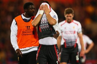 LONDON, ENGLAND - MAY 05:  Kolo Toure of Liverpool consoles the dejected Luis Suarez of Liverpool following their team's 3-3 draw during the Barclays Premier League match between Crystal Palace and Liverpool at Selhurst Park on May 5, 2014 in London, Engl