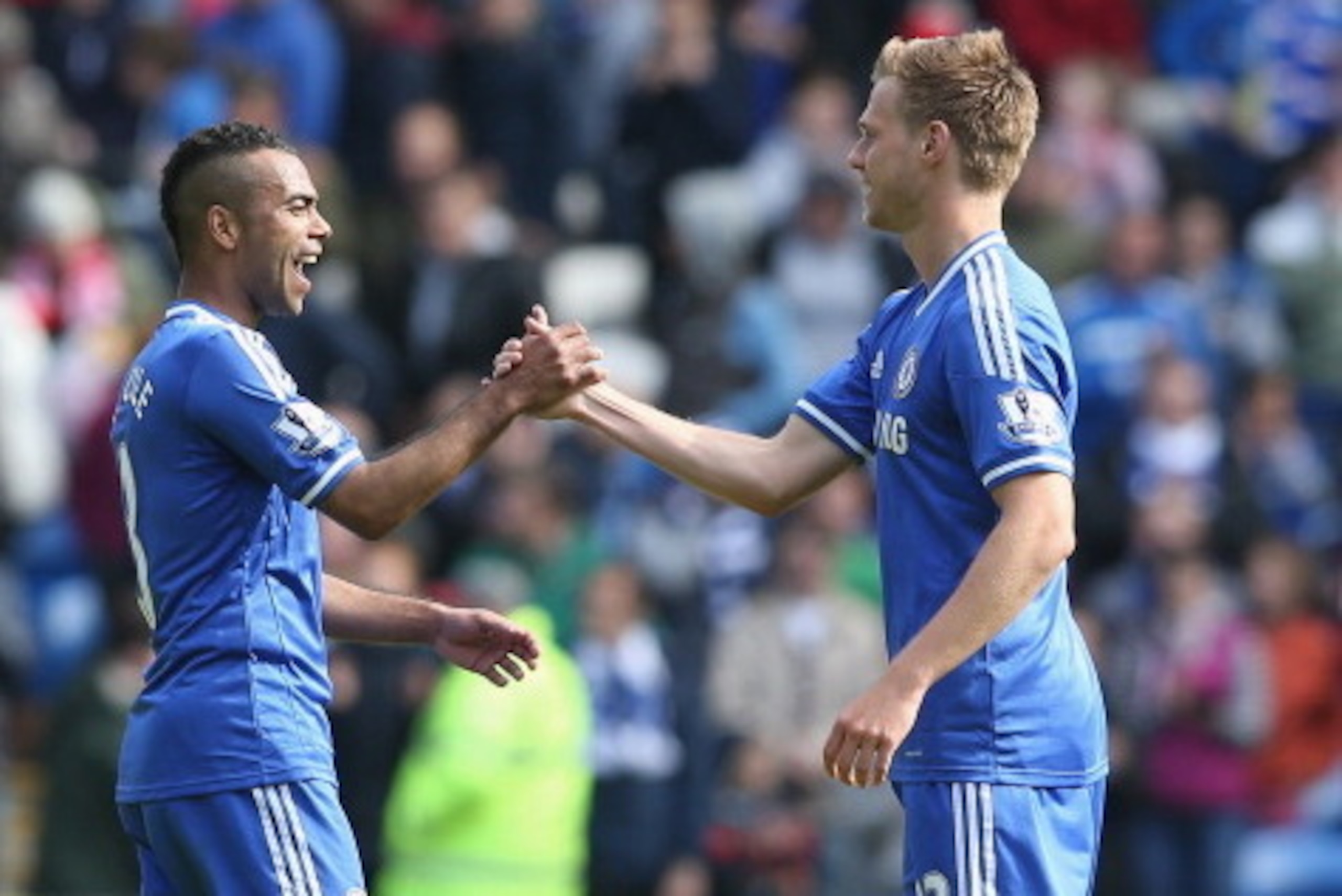 CARDIFF, WALES - MAY 11:  Ashley Cole (L) of Chelsea is congratulated by team mate Tomas Calas as he leaves the field after their victory during the Barclays Premier League match between Cardiff City and Chelsea at the Cardiff City Stadium on May 11, 2014