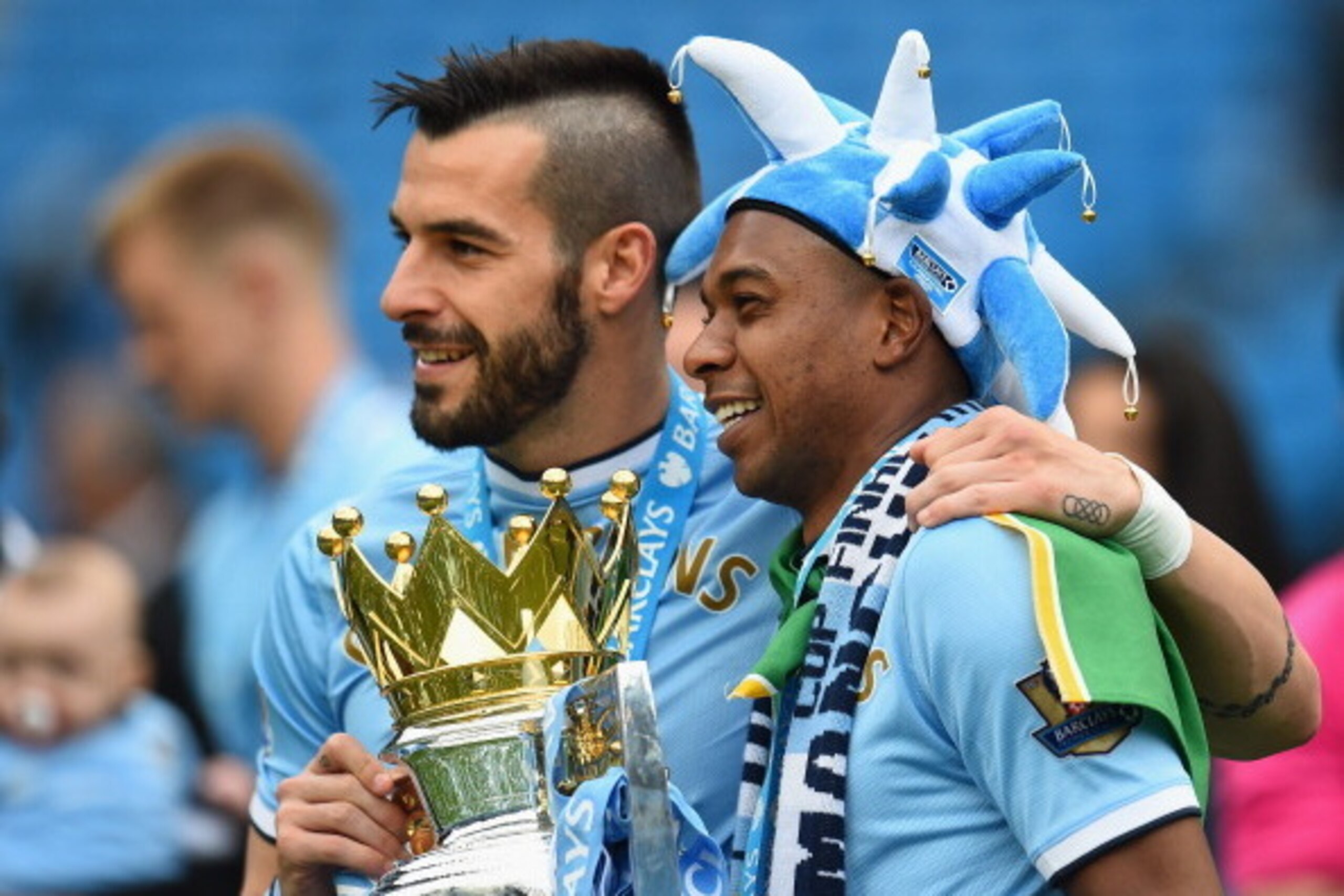 MANCHESTER, ENGLAND - MAY 11:  Alvaro Negredo and Fernandinho (R) of Manchester City pose with the trophy at the end of the Barclays Premier League match between Manchester City and West Ham United at the Etihad Stadium on May 11, 2014 in Manchester, Engl