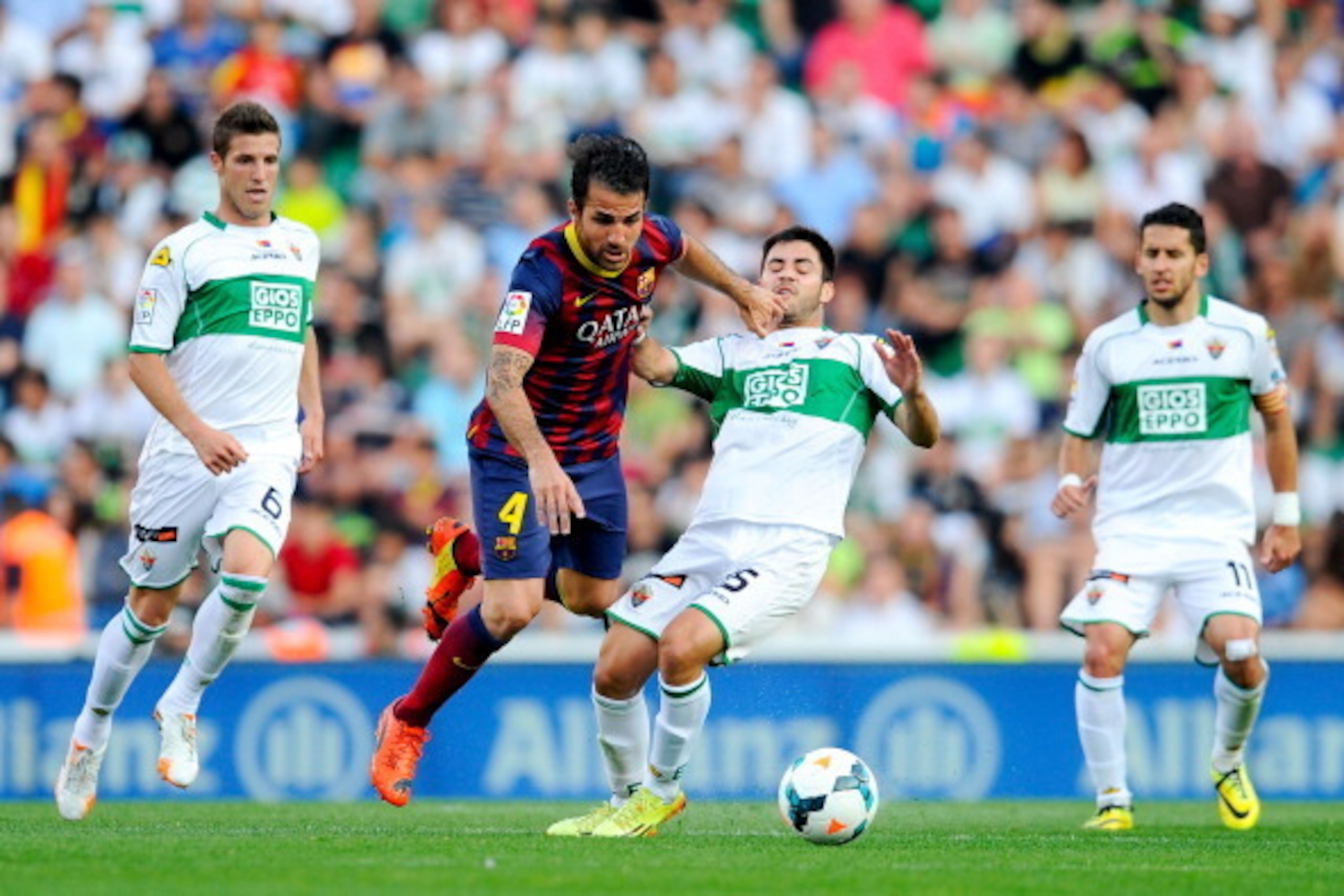 ELCHE, SPAIN - MAY 11:  Cesc Fabregas of FC Barcelona is brought down by Carles Gil of Elche FC during the La Liga match between Elche FC and FC Barcelona at Estadio Manuel Martinez Valero on May 11, 2014 in Elche, Spain.  (Photo by David Ramos/Getty Imag