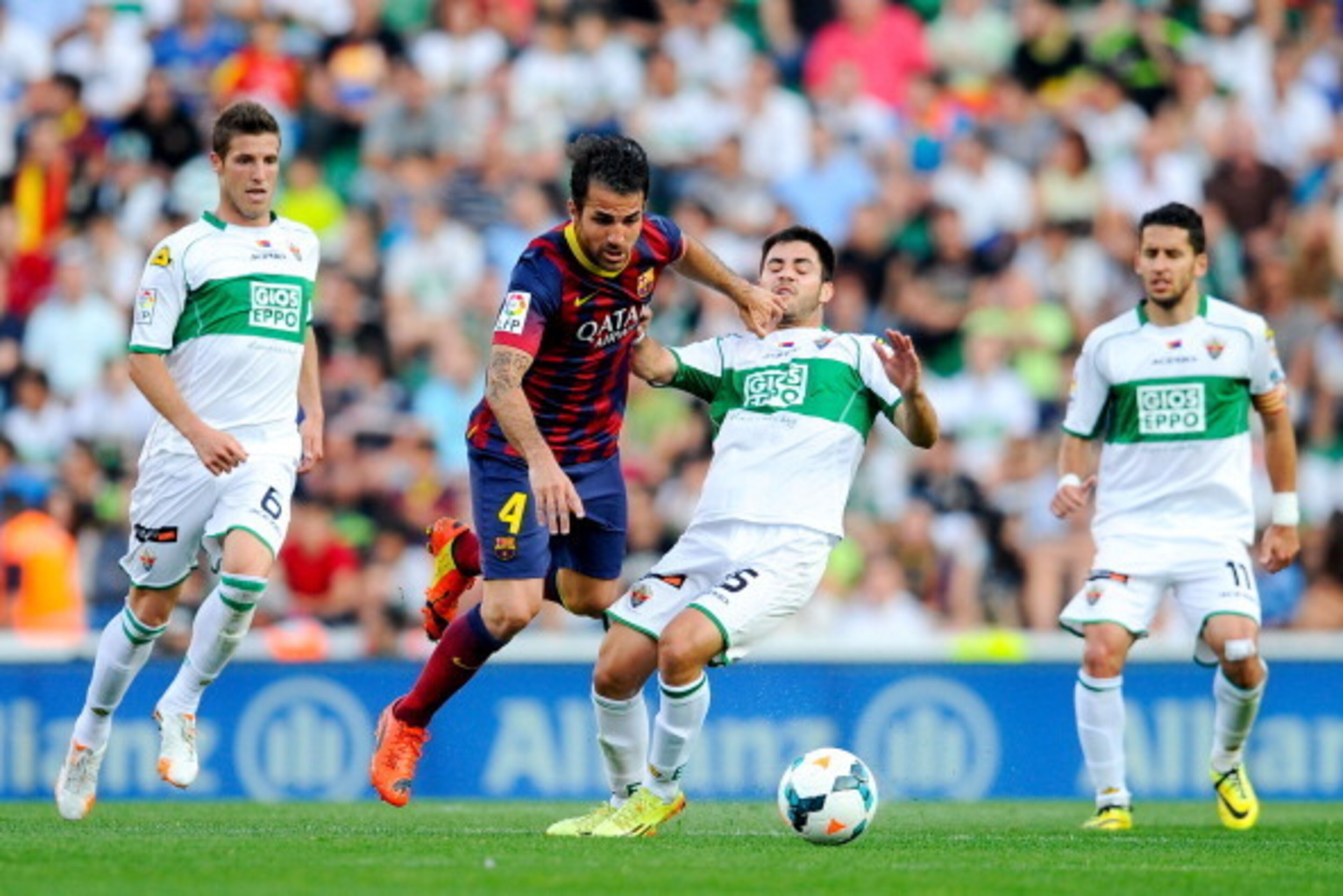 ELCHE, SPAIN - MAY 11: Cesc Fabregas of FC Barcelona is brought down by Carles Gil of Elche FC during the La Liga match between Elche FC and FC Barcelona at Estadio Manuel Martinez Valero on May 11, 2014 in Elche, Spain. (Photo by David Ramos/Getty Imag ELCHE, SPAIN - MAY 11: Cesc Fabregas of FC Barcelona is brought down by Carles Gil of Elche FC during the La Liga match between Elche FC and FC Barcelona at Estadio Manuel Martinez Valero on May 11, 2014 in Elche, Spain. (Photo by David Ramos/Getty Imag