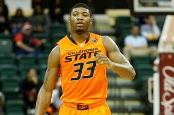 ORLANDO, FL - DECEMBER 01:  Marcus Smart #33 of the Oklahoma State Cowboys sets up the offense in a game against the Memphis Tigers during the Old Spice Classic at HP Field House on December 1, 2013 in Orlando, Florida.  (Photo by Sam Greenwood/Getty Imag