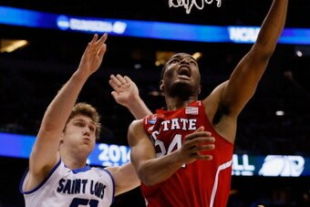 ORLANDO, FL - MARCH 20:  T.J. Warren #24 of the North Carolina State Wolfpack makes a layup in the first half against Rob Loe #51 and Jake Barnett #30 of the Saint Louis Billikens during the second round of the 2014 NCAA Men's Basketball Tournament at Amw