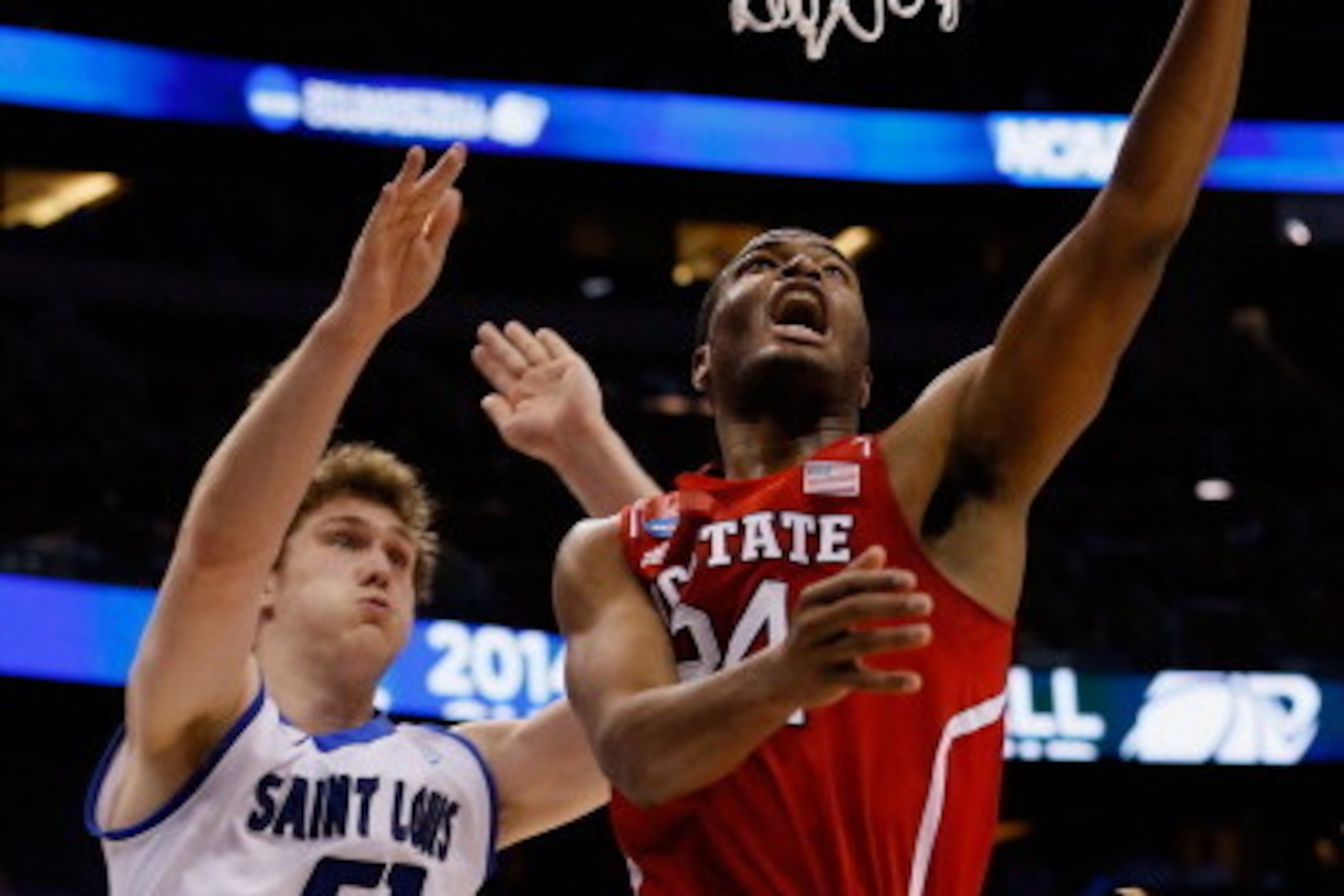 ORLANDO, FL - MARCH 20: T.J. Warren #24 of the North Carolina State Wolfpack makes a layup in the first half against Rob Loe #51 and Jake Barnett #30 of the Saint Louis Billikens during the second round of the 2014 NCAA Men's Basketball Tournament at Amw ORLANDO, FL - MARCH 20: T.J. Warren #24 of the North Carolina State Wolfpack makes a layup in the first half against Rob Loe #51 and Jake Barnett #30 of the Saint Louis Billikens during the second round of the 2014 NCAA Men's Basketball Tournament at Amw