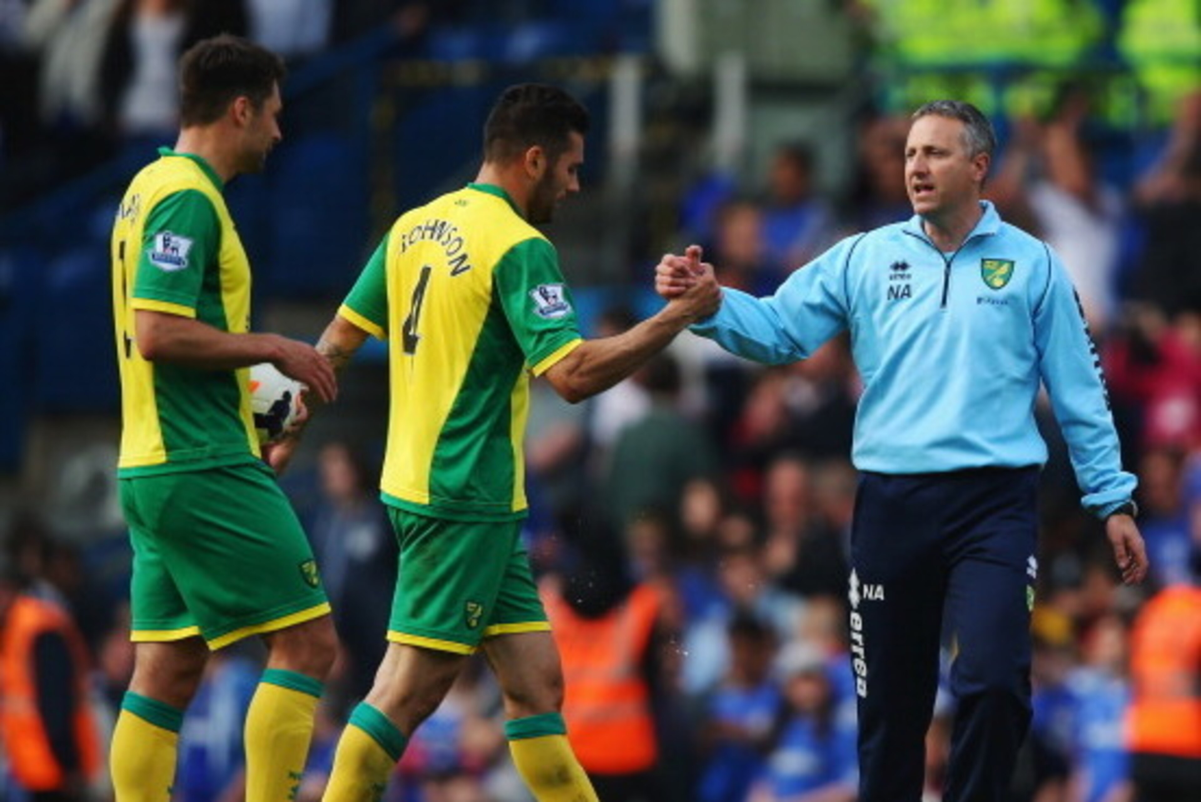LONDON, ENGLAND - MAY 04:  Norwich City manager Neil Adams commiserates with Bradley Johnson following the Barclays Premier League match between Chelsea and Norwich City at Stamford Bridge on May 4, 2014 in London, England.  (Photo by Clive Rose/Getty Ima
