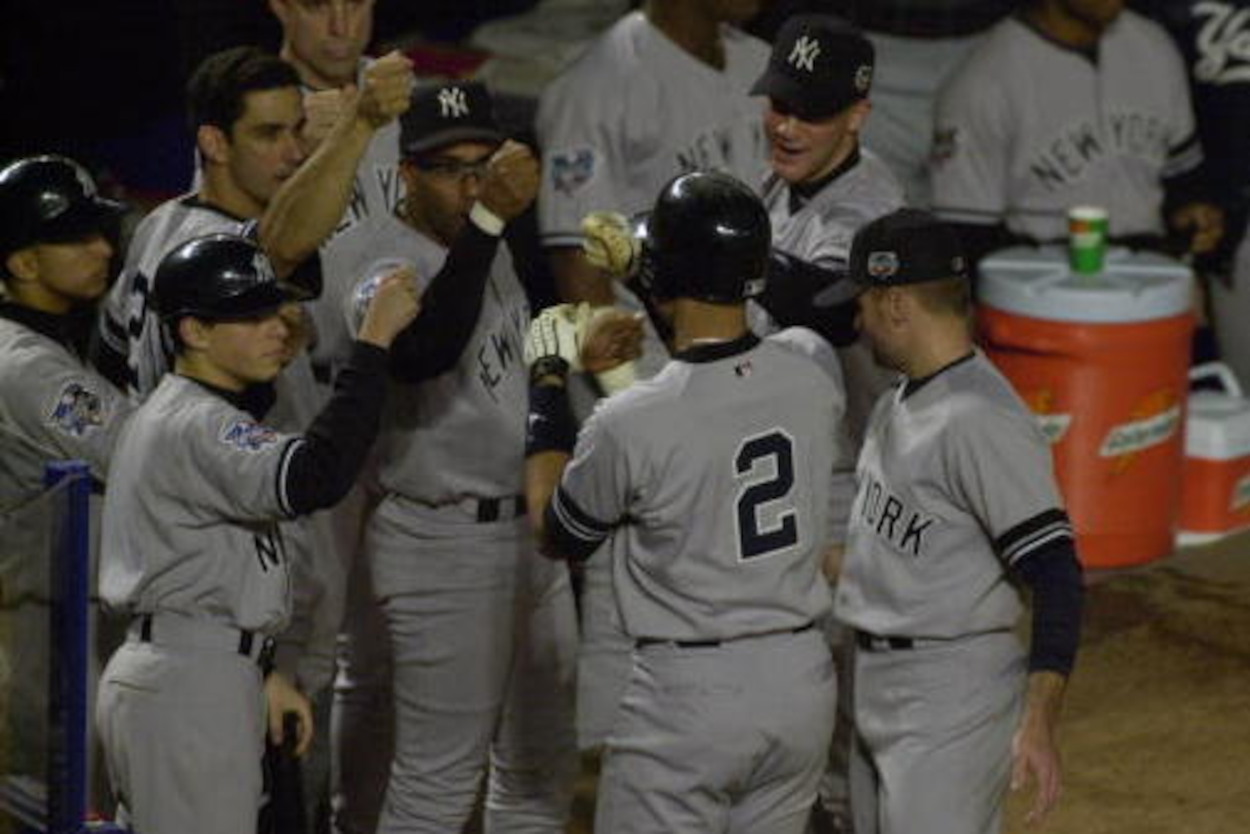 25 Oct 2000:  Derek Jeter #2 of the New York Yankees is congratulated as he heads into the dugout after hitting a solo home run in the first inning against the New York Mets during Game 4 of the World Series at Shea Stadium in Flushing, New York. The Yank