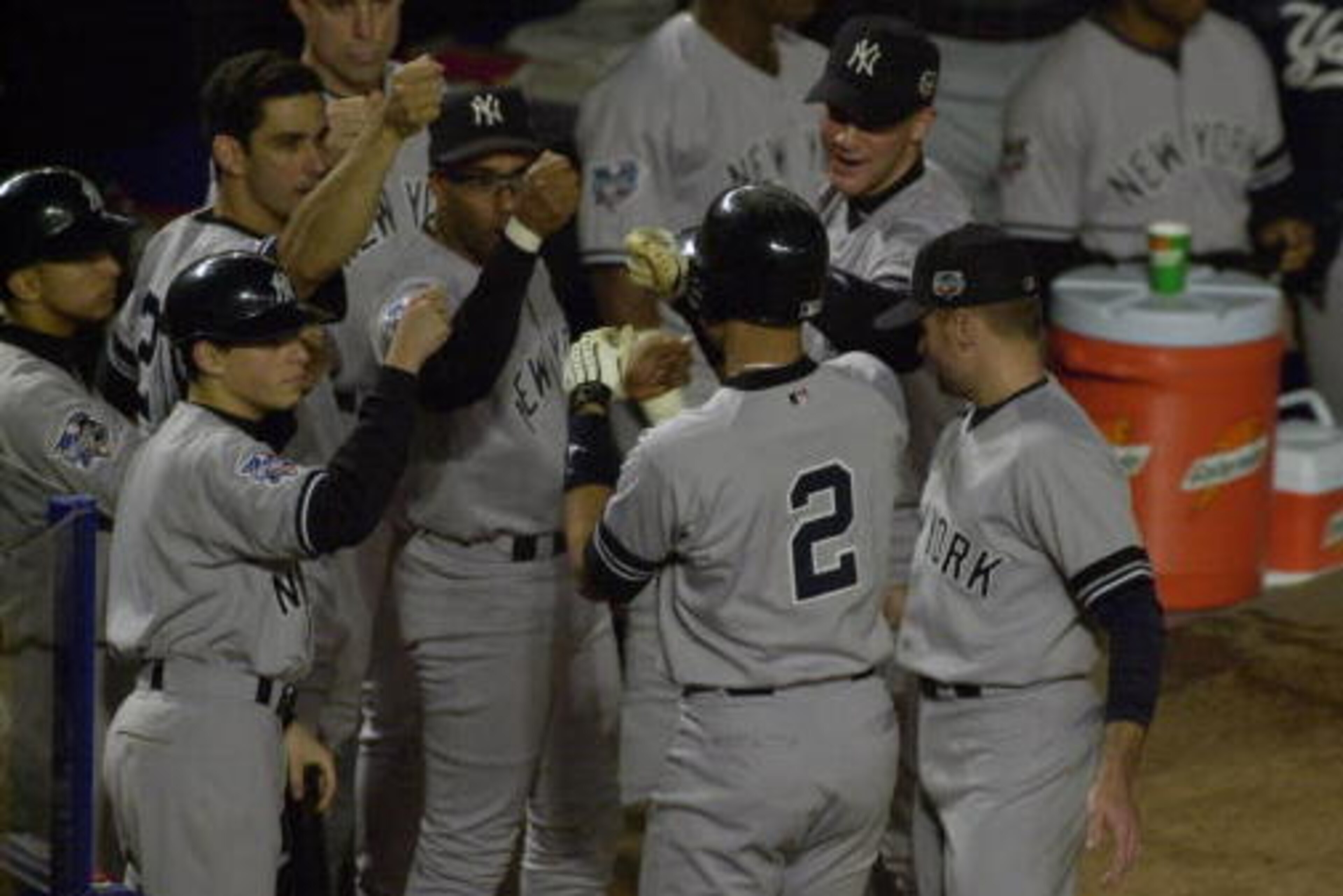 25 Oct 2000:  Derek Jeter #2 of the New York Yankees is congratulated as he heads into the dugout after hitting a solo home run in the first inning against the New York Mets during Game 4 of the World Series at Shea Stadium in Flushing, New York. The Yank