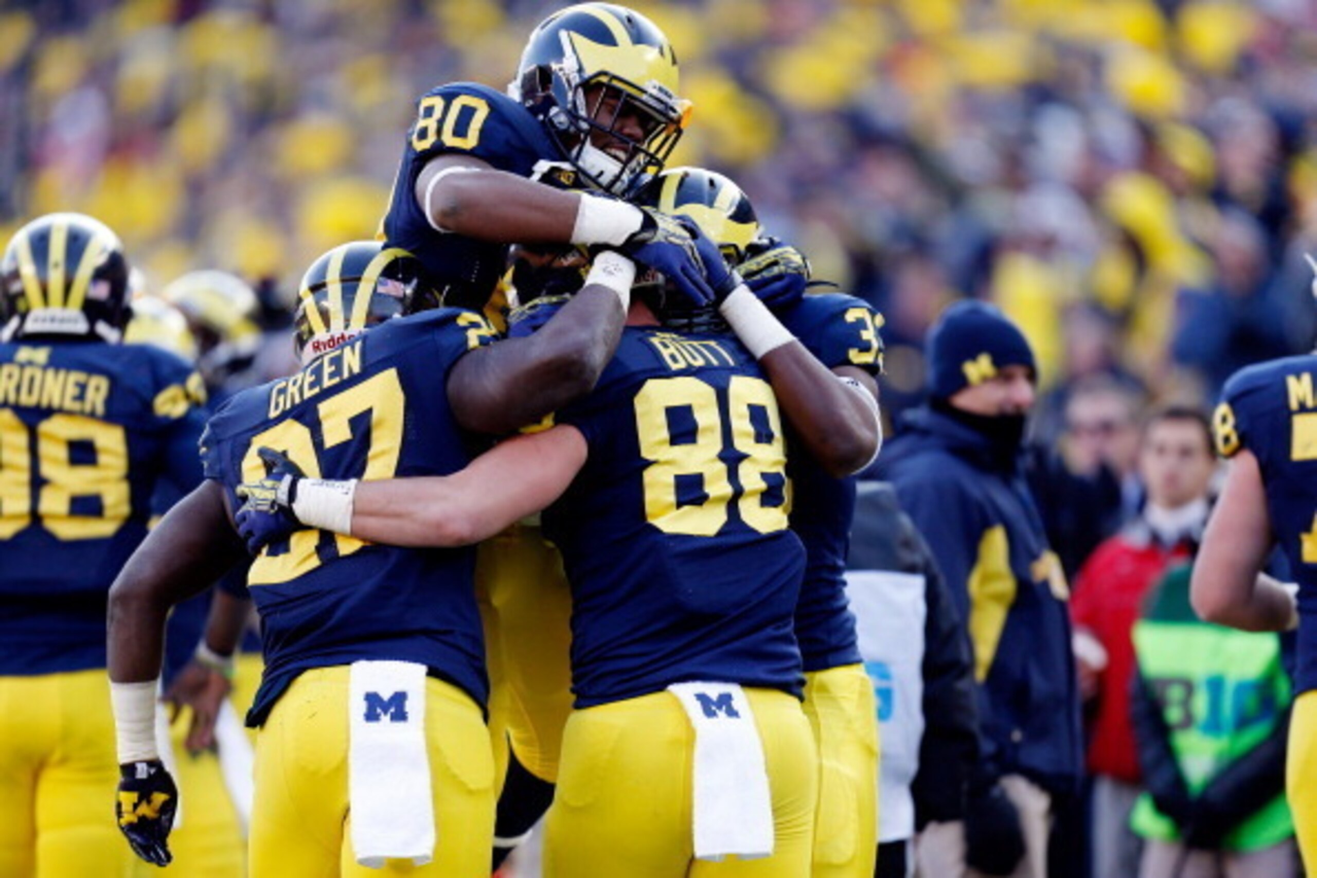 ANN ARBOR, MI - NOVEMBER 30:  Tight end Jake Butt #88 of the Michigan Wolverines celebrates a fourth quarter touchdown with tight end Khalid Hill #80 and running back Derrick Green #27 against the Ohio State Buckeyes during a game at Michigan Stadium on N