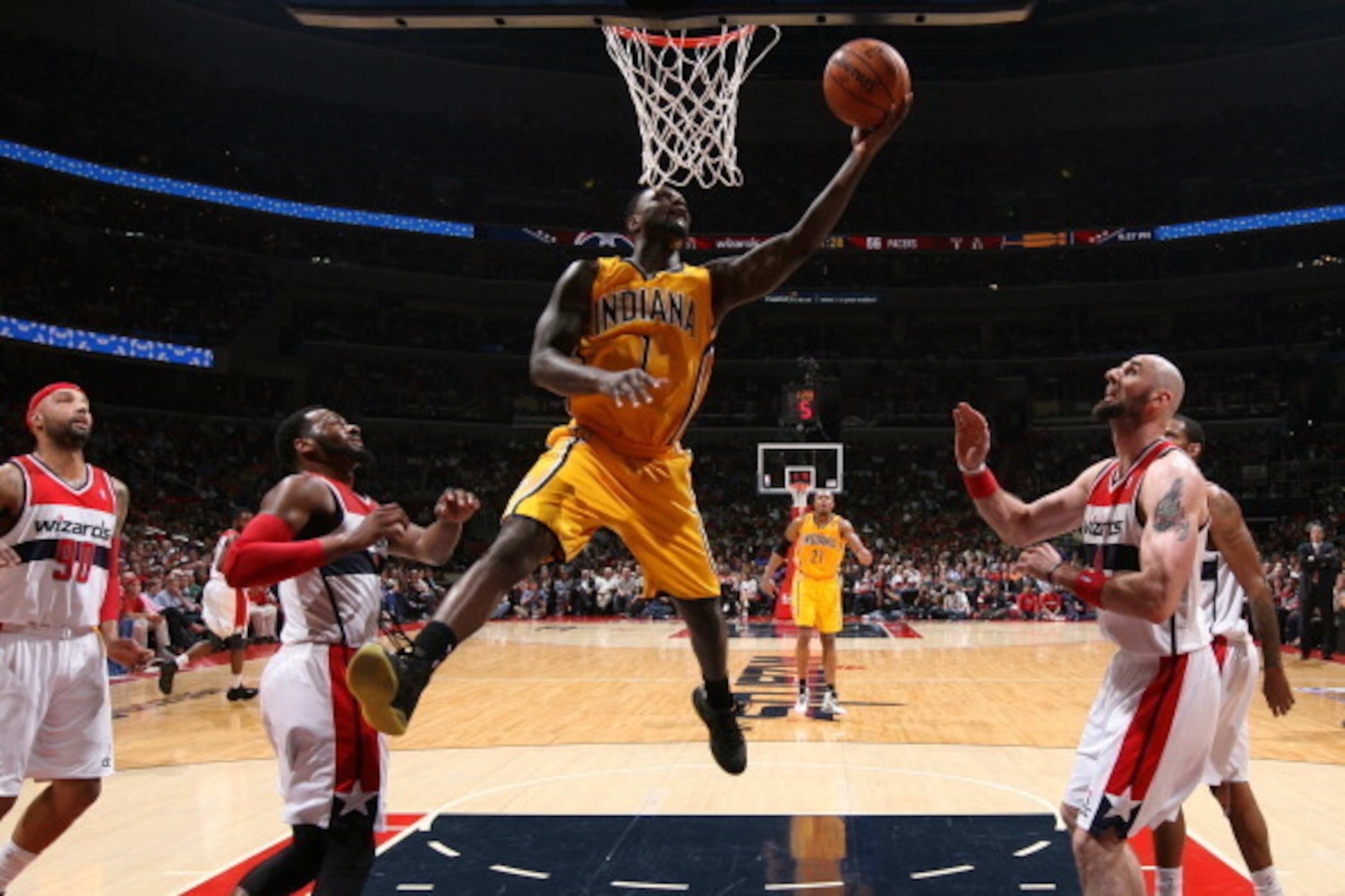WASHINGTON, DC - MAY 9: Lance Stephenson #1 of the Indiana Pacers shoots against John Wall #2 and Marcin Gortat #4 of the Washington Wizards in Game Three of the Eastern Conference Semifinals during the 2014 NBA Playoffs at the Verizon Center on May 9, 20 WASHINGTON, DC - MAY 9: Lance Stephenson #1 of the Indiana Pacers shoots against John Wall #2 and Marcin Gortat #4 of the Washington Wizards in Game Three of the Eastern Conference Semifinals during the 2014 NBA Playoffs at the Verizon Center on May 9, 20