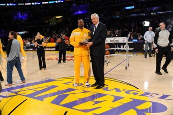 LOS ANGELES, CA - FEBRUARY 17:  Kobe Bryant #24 of the Los Angeles Lakers is presented with the Western Conference Player of the Week award from General Manager Mitch Kupchak before a game against the Phoenix Suns at Staples Center on February 17, 2012 in