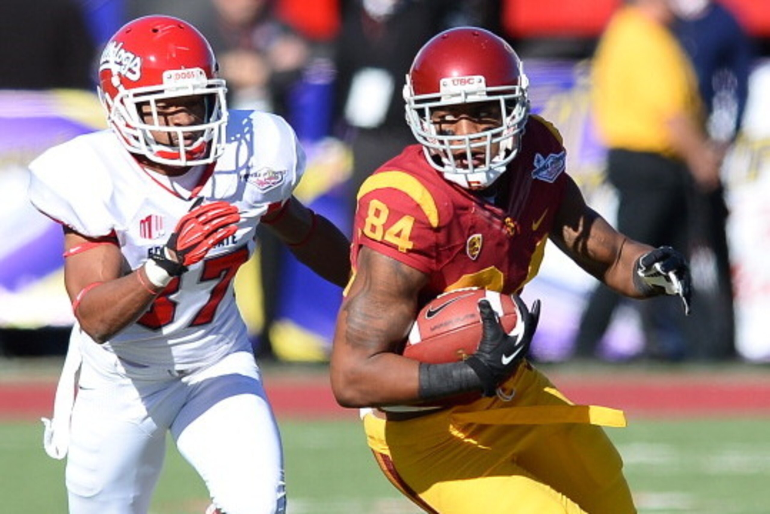 LAS VEGAS, NV - DECEMBER 21:  Darreus Rogers #84 of the USC Trojans runs for yardage ahead of Jonathan Norton #37 of the Fresno State Bulldogs during the Royal Purple Las Vegas Bowl at Sam Boyd Stadium on December 21, 2013 in Las Vegas, Nevada. USC won 45
