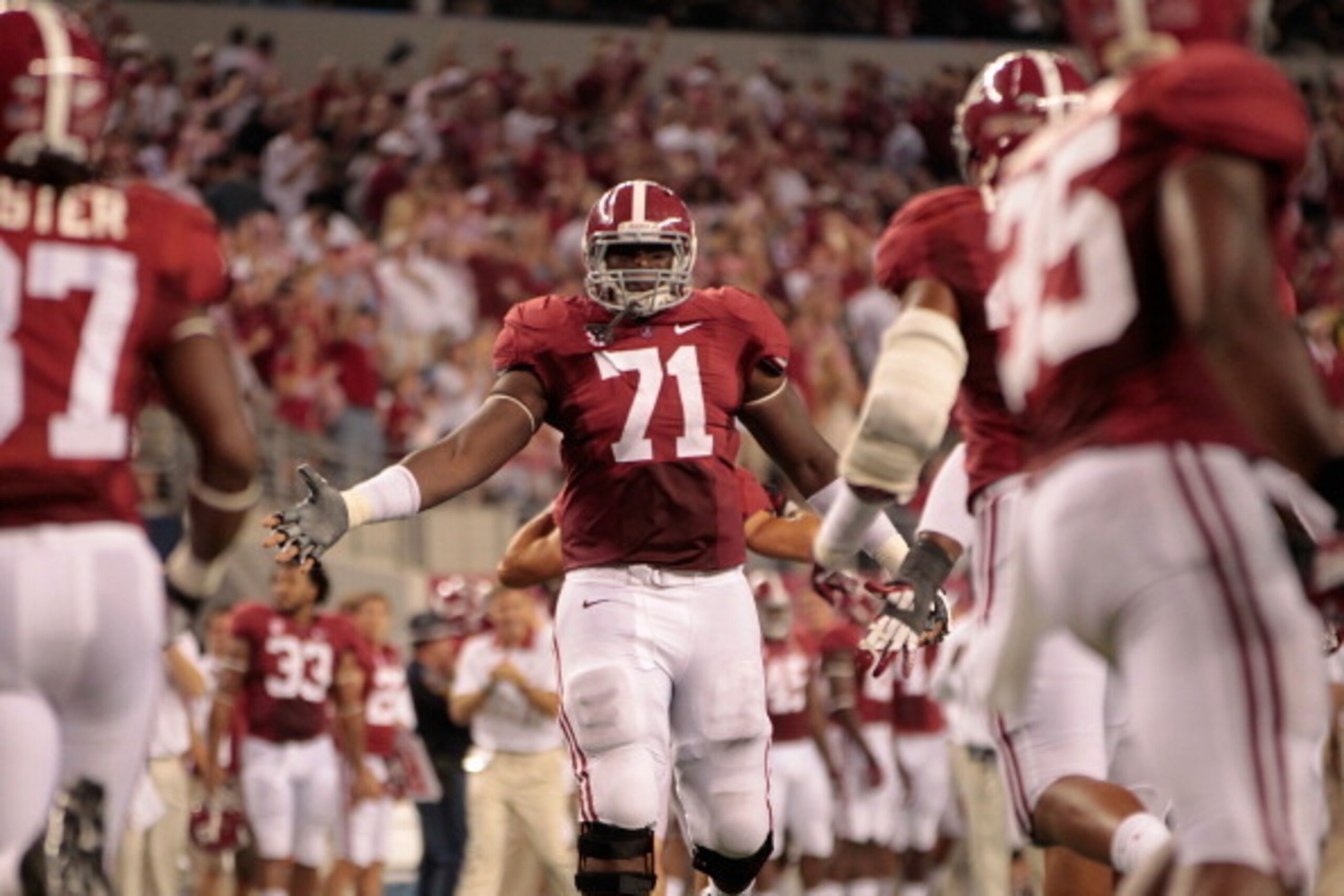ARLINGTON, TX - SEPTEMBER 01: Cyrus Kouandjio #71 of the University of Alabama reacts after a big stop during the game against the University of Michigan at Cowboys Stadium on September 1, 2012 in Arlington, Texas. Alabama defeated Michigan 41-14.  (Photo