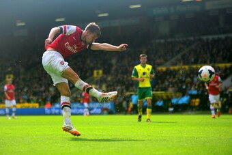 NORWICH, ENGLAND - MAY 11: Aaron Ramsey of Arsenal scores the opening goal during the Barclays Premier League match between Norwich City and Arsenal at Carrow Road on May 11, 2014 in Norwich, England.  (Photo by Jamie McDonald/Getty Images)