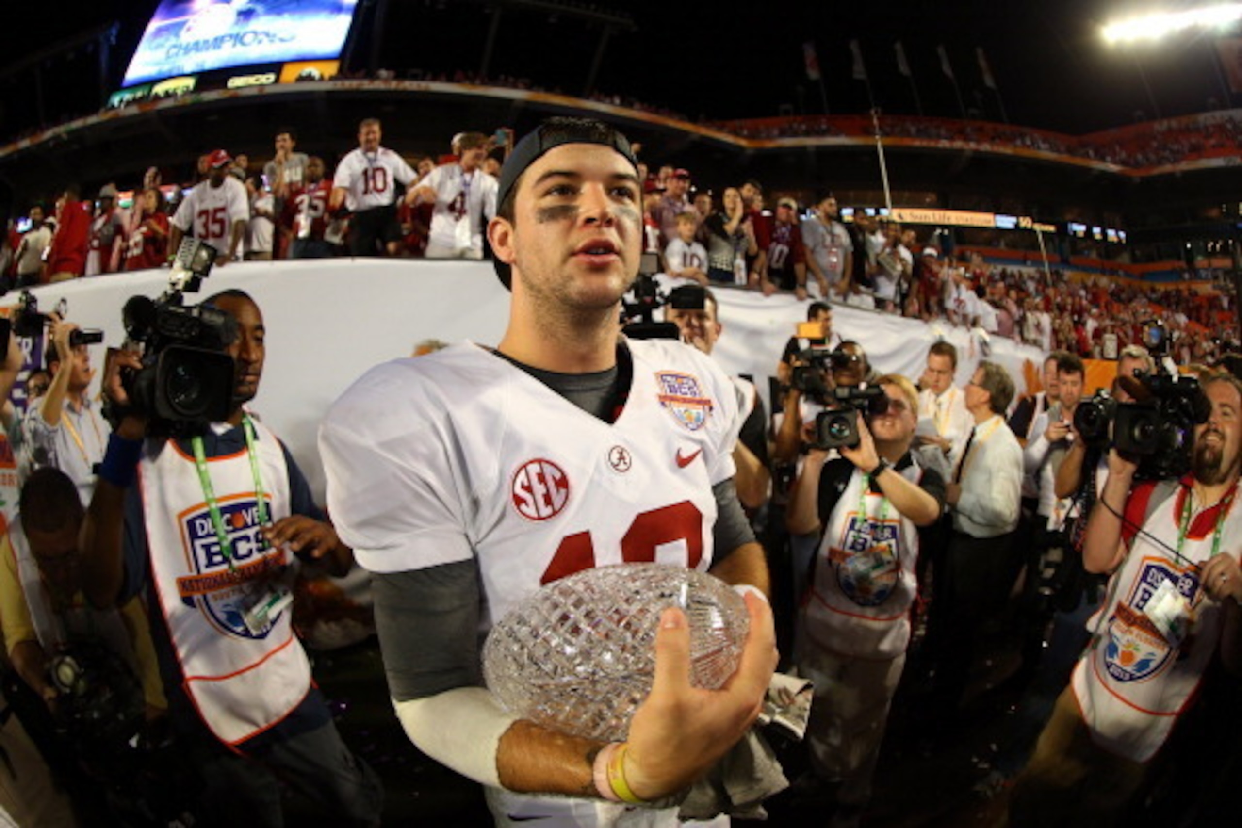 MIAMI GARDENS, FL - JANUARY 07:  AJ McCarron #10 of the Alabama Crimson Tide celebrates with the Coach's Trophy after defeating the Notre Dame Fighting Irish by a score of 42-14 to win the 2013 Discover BCS National Championship game at Sun Life Stadium o