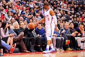 LOS ANGELES, CA - FEBRUARY 13: Chris Paul #3 of the Los Angeles Clippers tosses a basketball to team owner Donald Sterling during a game against the Houston Rockets at Staples Center on February 13, 2013 in Los Angeles, California. NOTE TO USER: User expr