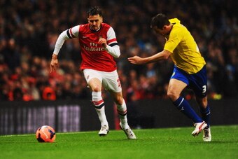 LONDON, ENGLAND - JANUARY 24:  Carl Jenkinson of Arsenal chases the ball with Blair Adams of Coventry City during the FA Cup with Budweiser Fourth round match between Arsenal and Coventry City at Emirates Stadium on January 24, 2014 in London, England.  (