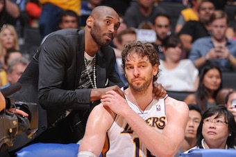 LOS ANGELES, CA - APRIL 28: Kobe Bryant #24 of the Los Angeles Lakers greets teammate Pau Gasol #16 on the bench as their team plays against the San Antonio Spurs in Game Four of the Western Conference Quarterfinals during the 2013 NBA Playoffs at Staples