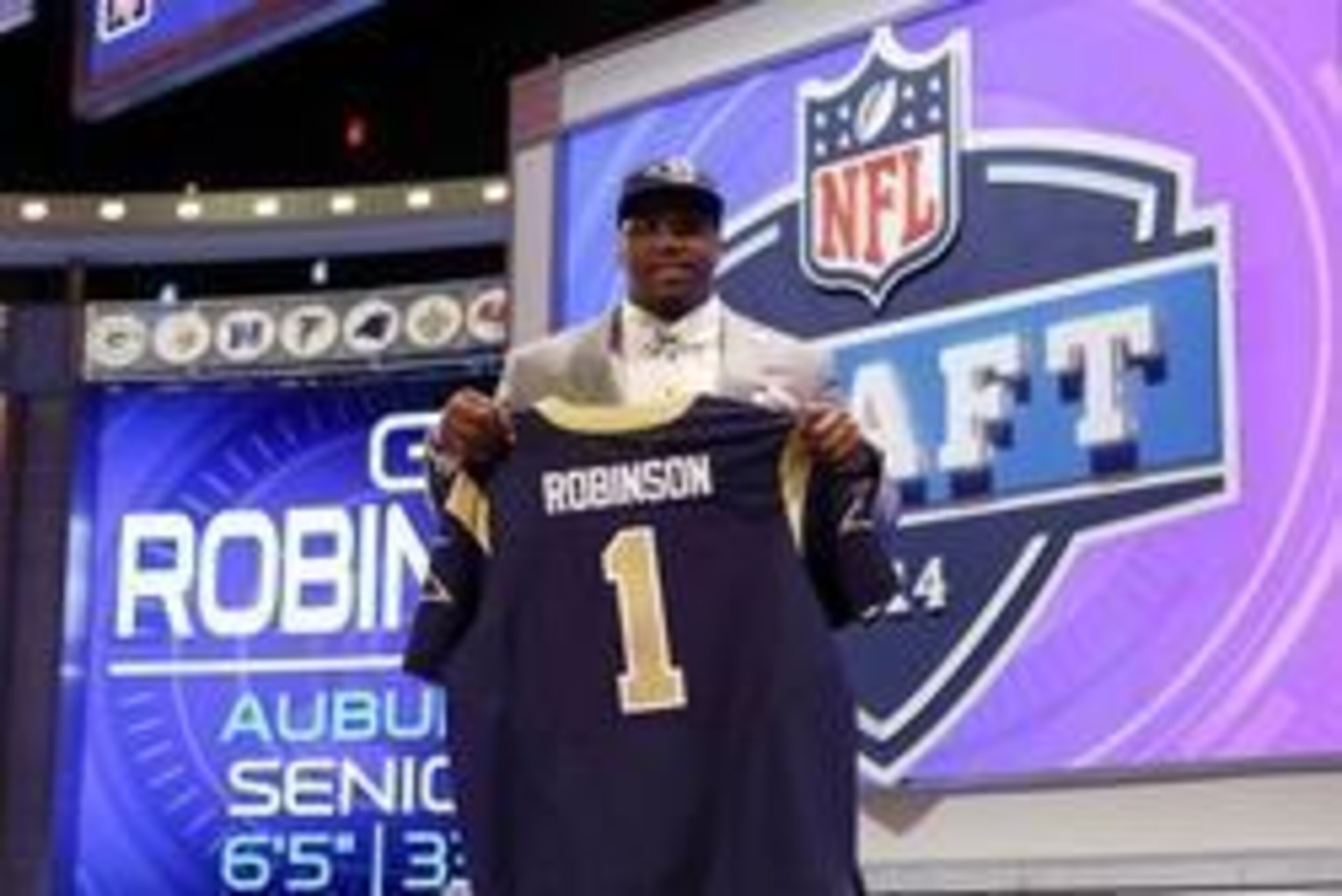 May 8, 2014; New York, NY, USA; Greg Robinson (Auburn) poses with a jersey after being selected as the number two overall pick in the first round of the 2014 NFL Draft to the St. Louis Rams at Radio City Music Hall. Mandatory Credit: Adam Hunger-USA TODAY