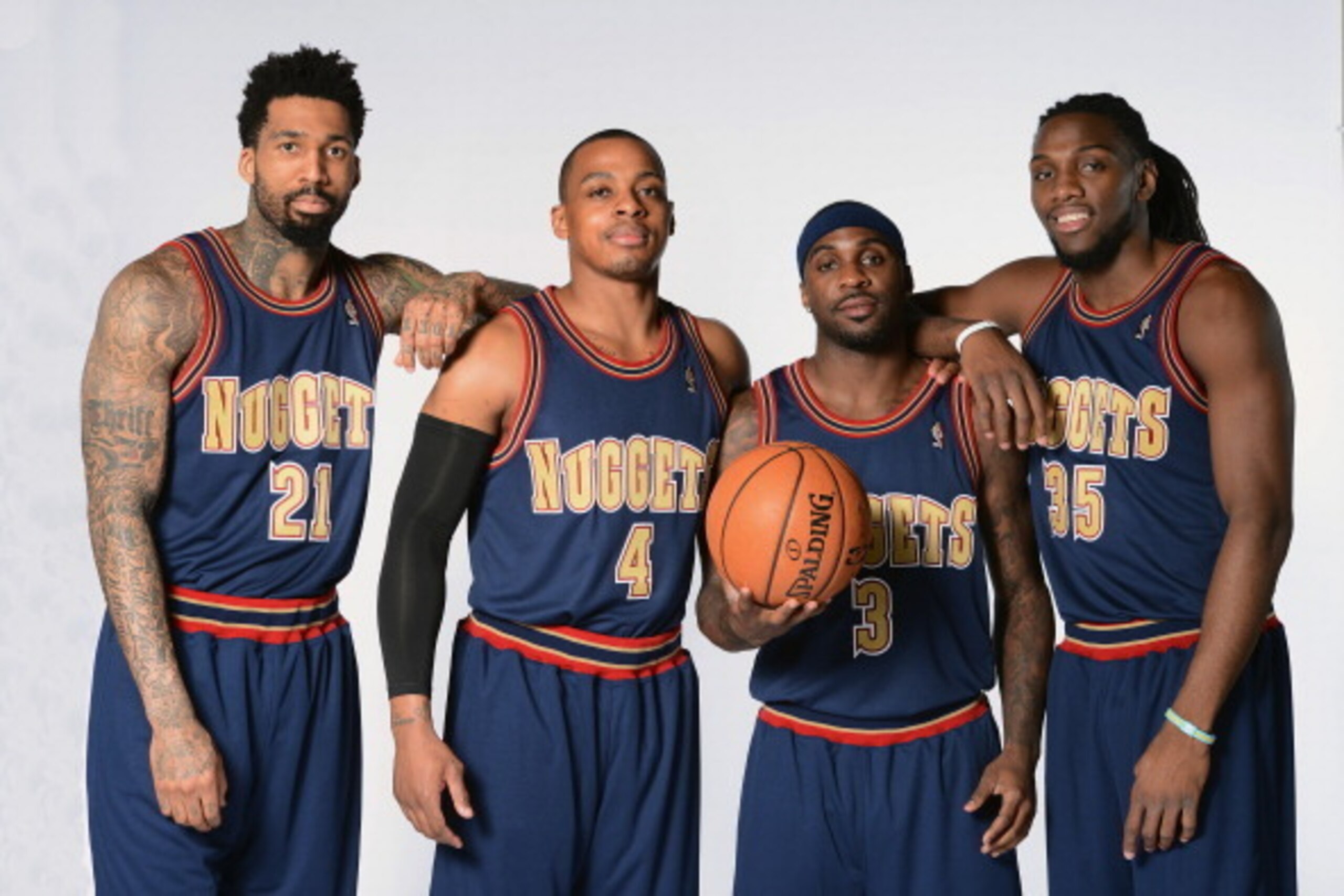 DENVER, CO - MARCH 4: Wilson Chandler #21 Randy Foye #4, Ty Lawson #3 and Kenneth Faried #35 of the Denver Nuggets pose for photos wearing the uniforms from the 1993-1994 season on March 4, 2014 at the Pepsi Center in Denver, Colorado. NOTE TO USER: User 