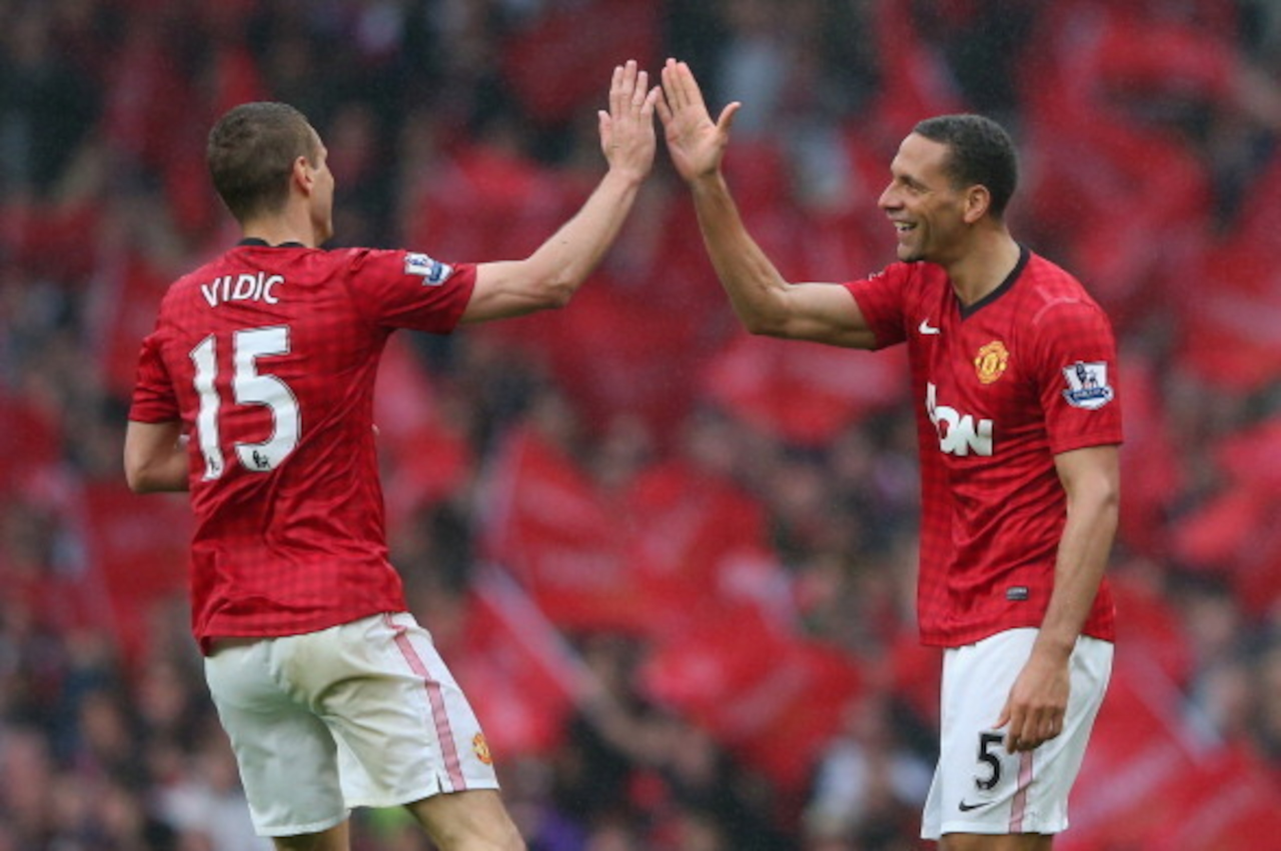 MANCHESTER, ENGLAND - MAY 12:  Rio Ferdinand of Manchester United celebrates scoring the winning goal with team-mate Nemanja Vidic during the Barclays Premier League match between Manchester United and Swansea City at Old Trafford on May 12, 2013 in Manch