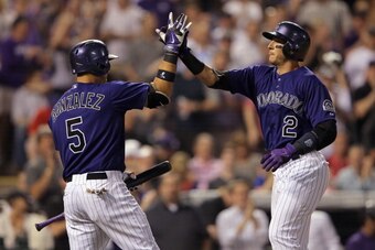 DENVER, CO - MAY 05:  Troy Tulowitzki #2 of the Colorado Rockies celebrates his two run home run off of starting pitcher Martin Perez #33 of the Texas Rangers with Carlos Gonzalez #5 of the Colorado Rockies to give the Rockies a 5-0 lead in the fifth inni