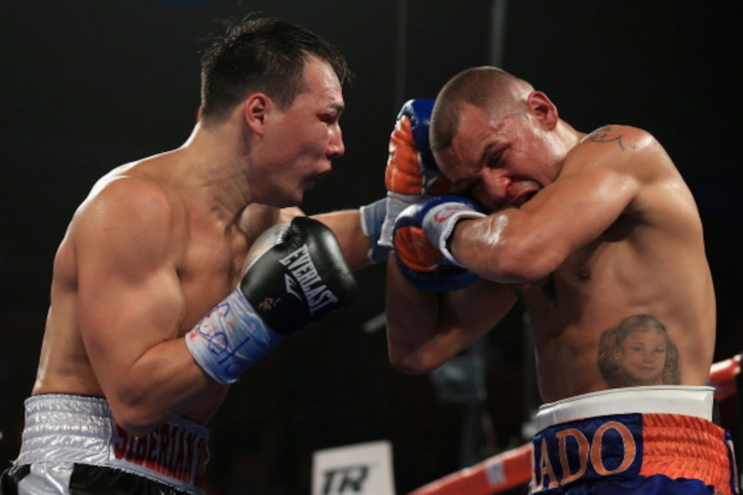 BROOMFIELD, CO - OCTOBER 19:  Ruslan Provodnikov (L) of Russia delivers a punch to Mike Alvarado (R) as Provodnikov won their bout with a TKO in the 10th round to claim the WBO Junior Welterweight Title at the 1stBank Center on October 19, 2013 in Broomfi