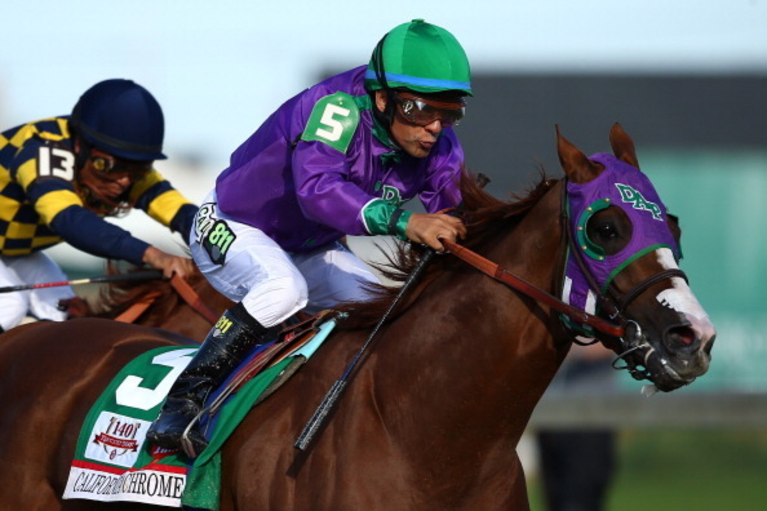 LOUISVILLE, KY - MAY 03:  Jockey Victor Espinoza guides California Chrome #5 to the finish line to win the 140th running of the Kentucky Derby at Churchill Downs on May 3, 2014 in Louisville, Kentucky.  (Photo by Andy Lyons/Getty Images)