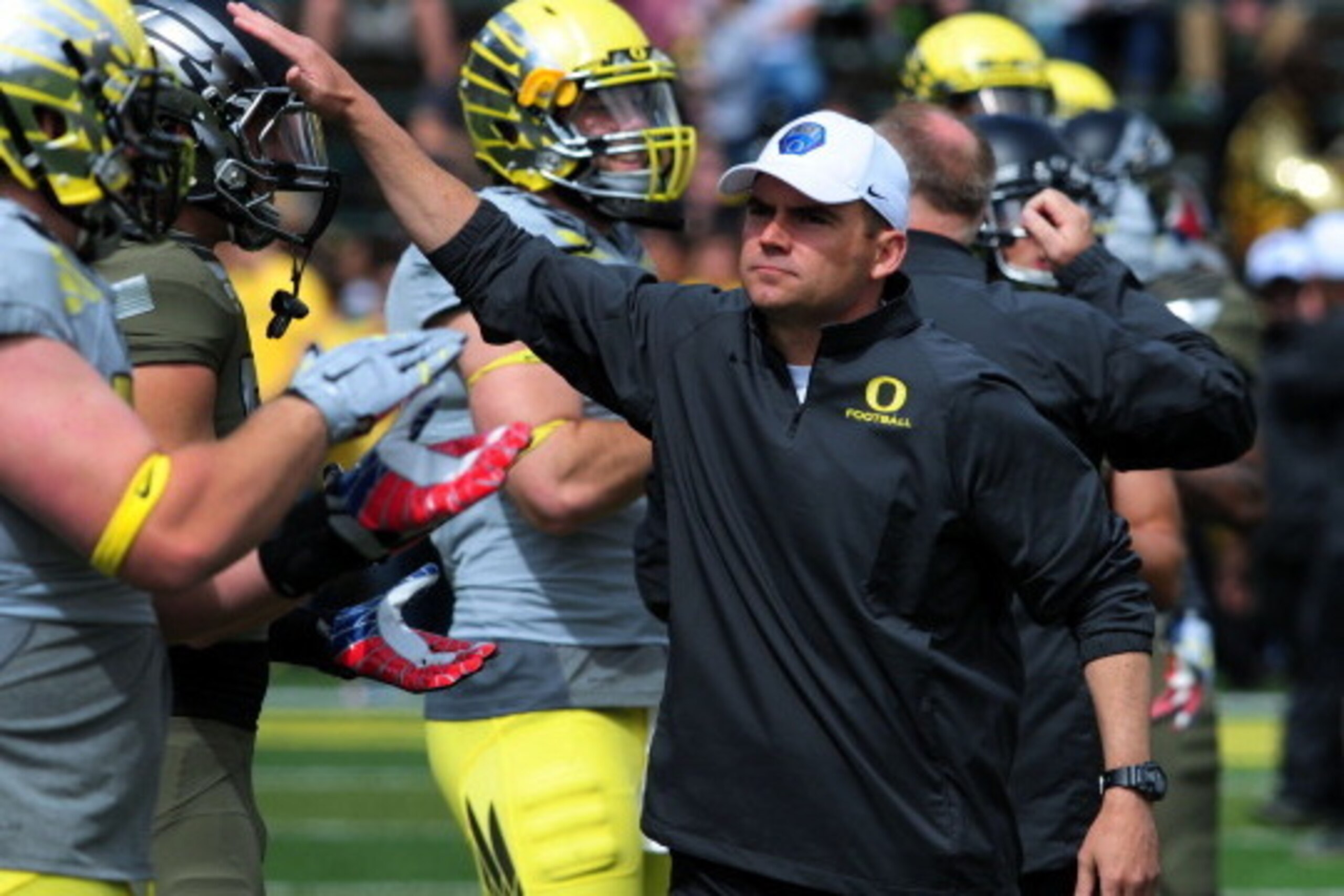 EUGENE, OR - MAY 3: Oregon Ducks head coach Mark Helfrich greets his players  before the Spring game at Autzen Stadium on May 3, 2014 in Eugene, Oregon. (Photo by Steve Dykes/Getty Images)