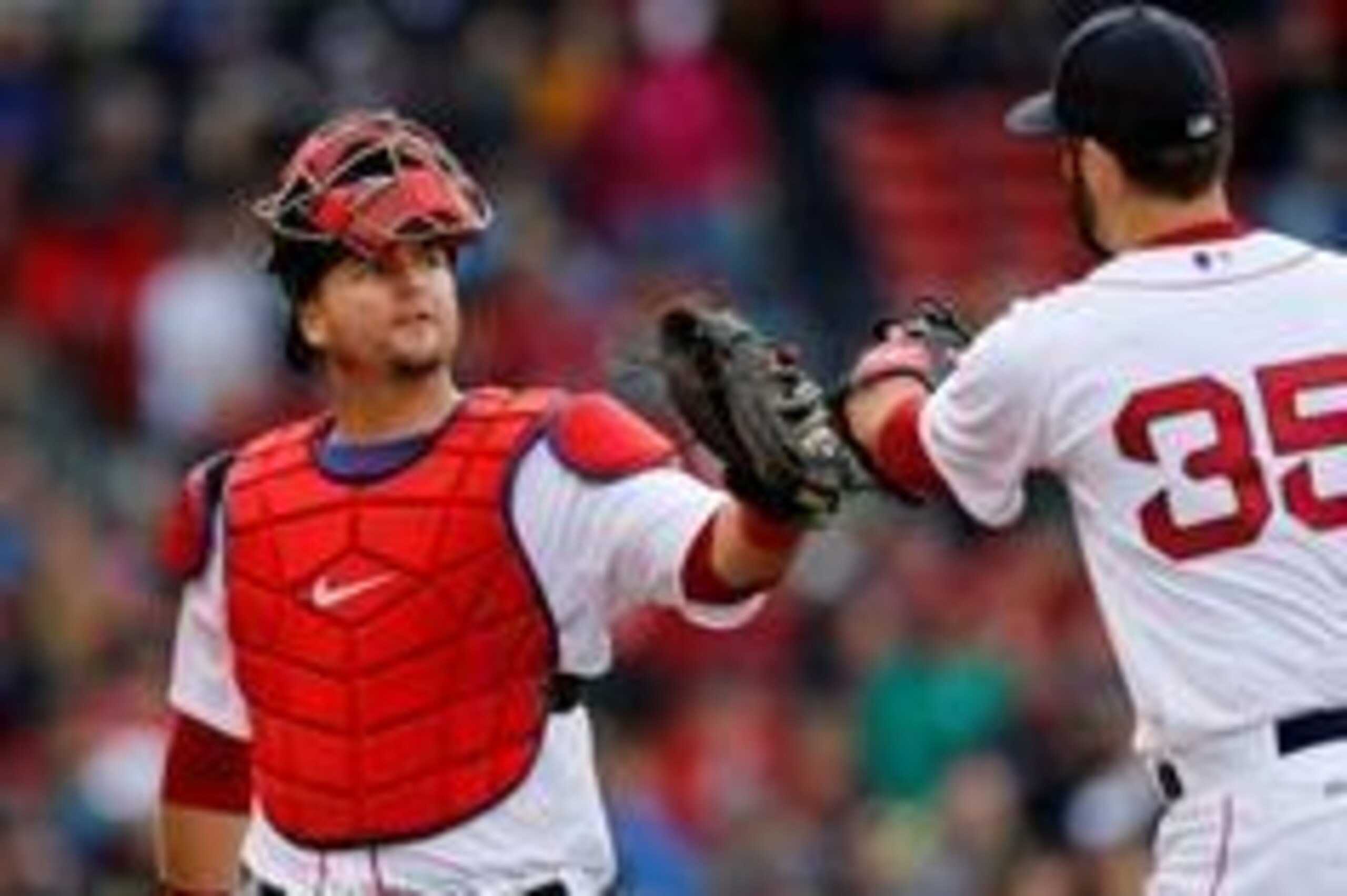May 4, 2014; Boston, MA, USA; Boston Red Sox catcher A.J. Pierzynski (40) touches gloves with pitcher Burke Badenhop (35) during the tenth inning against the Oakland Athletics at Fenway Park. Mandatory Credit: Greg M. Cooper-USA TODAY Sports