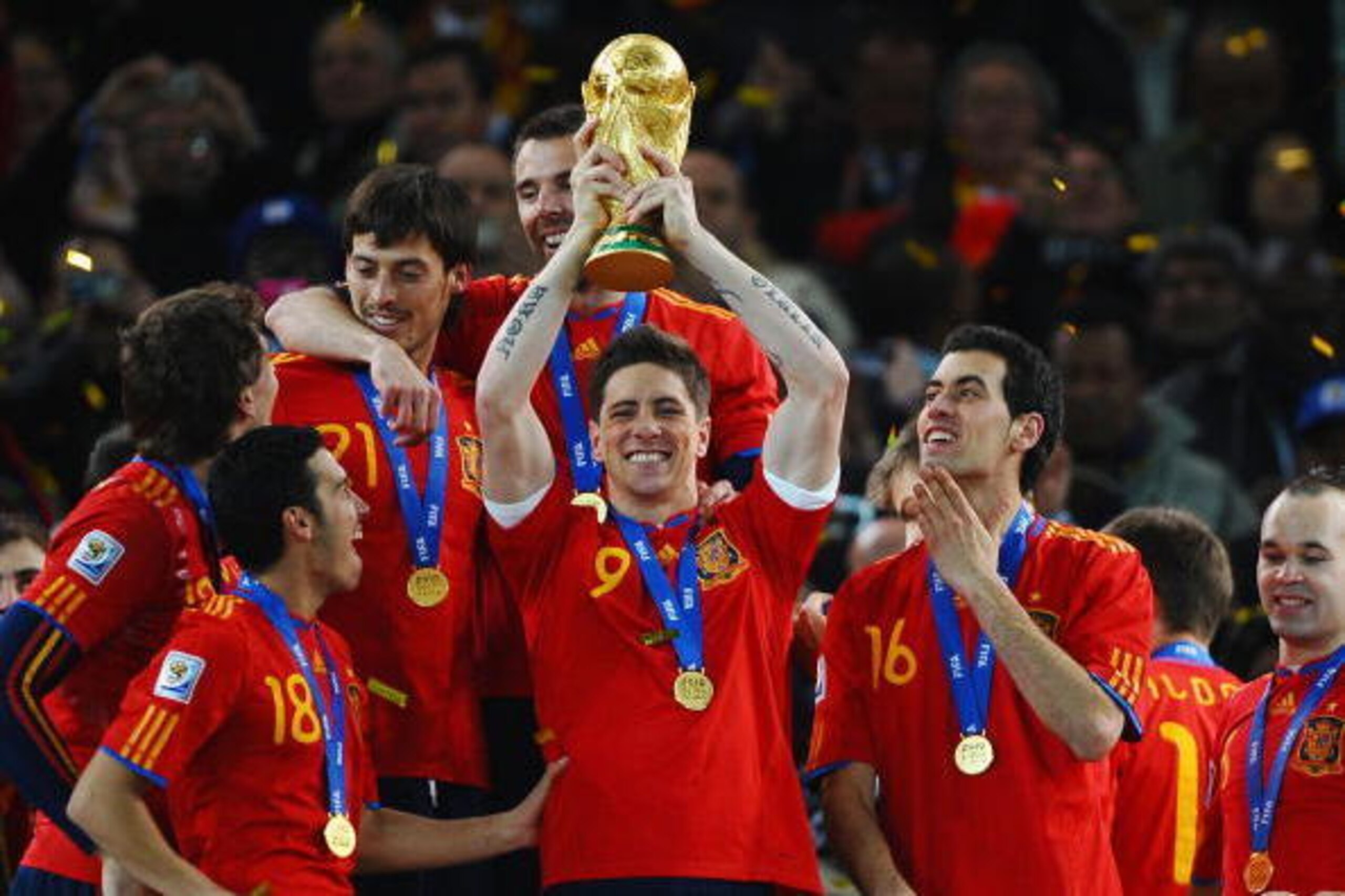 JOHANNESBURG, SOUTH AFRICA - JULY 11: Fernando Torres of Spain lifts the World Cup trophy as the Spain team celebrate victory following the 2010 FIFA World Cup South Africa Final match between Netherlands and Spain at Soccer City Stadium on July 11, 2010 JOHANNESBURG, SOUTH AFRICA - JULY 11: Fernando Torres of Spain lifts the World Cup trophy as the Spain team celebrate victory following the 2010 FIFA World Cup South Africa Final match between Netherlands and Spain at Soccer City Stadium on July 11, 2010