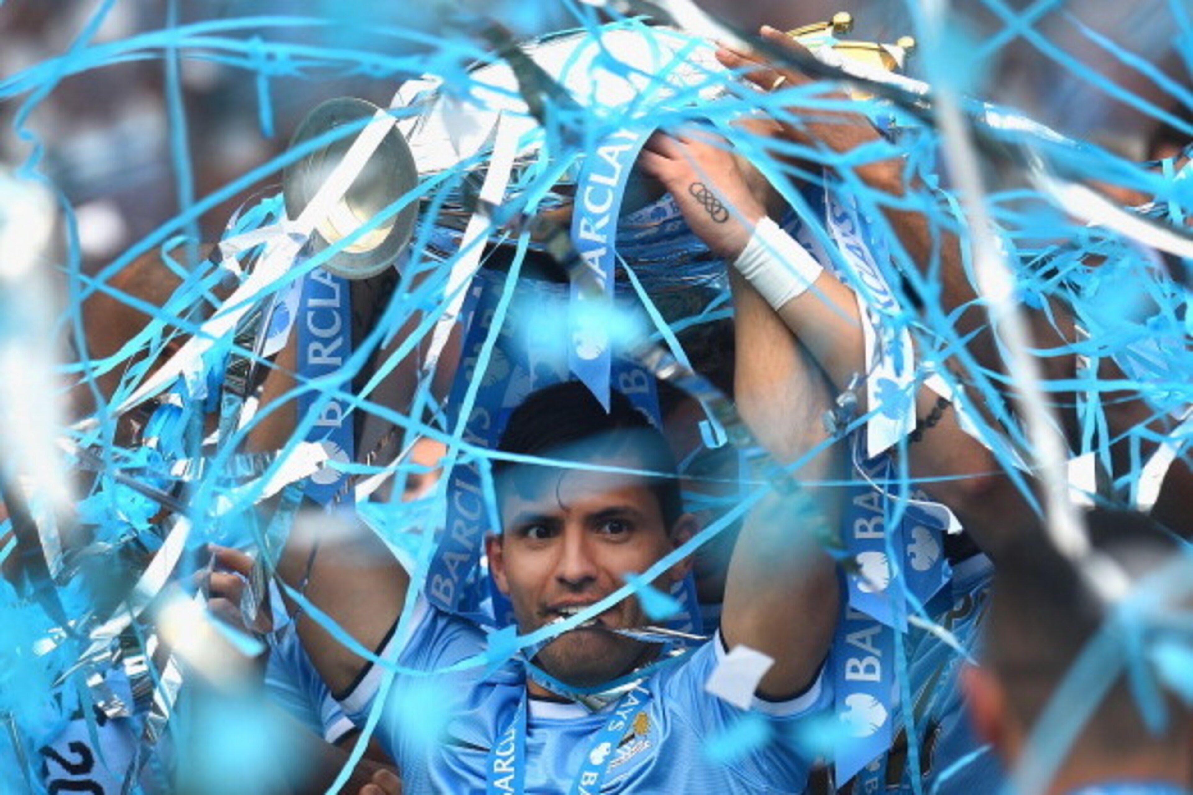 MANCHESTER, ENGLAND - MAY 11:  Sergio Aguero of Manchester City lifts the Premier League trophy at the end of the Barclays Premier League match between Manchester City and West Ham United  at Etihad Stadium on May 11, 2014 in Manchester, England.  (Photo 