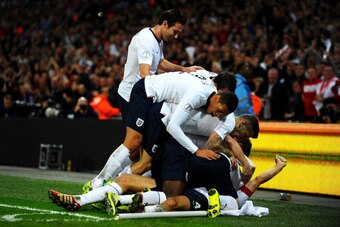 LONDON, ENGLAND - OCTOBER 15:  Steven Gerrard of England (obscured) celebrates with team mates as he scores their second goal during the FIFA 2014 World Cup Qualifying Group H match between England and Poland at Wembley Stadium on October 15, 2013 in Lond