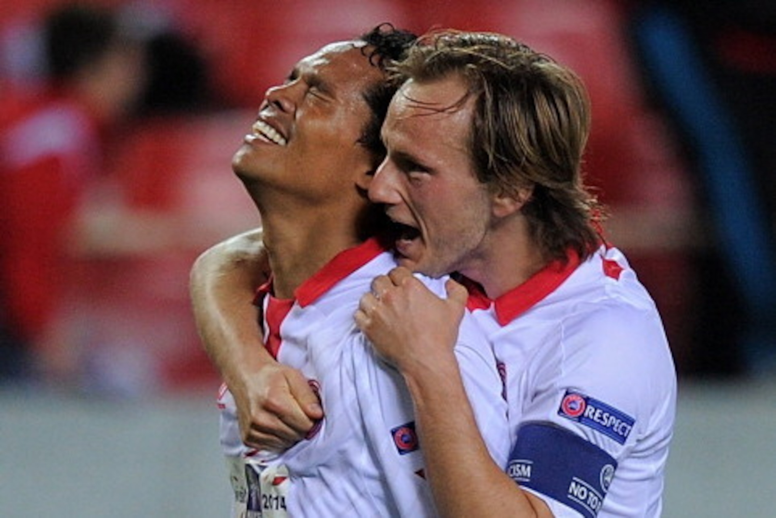 SEVILLE, SPAIN - APRIL 24:  Carlos Bacca (L) of Sevilla FC celebrates with Ivan Rakitic after scoring Sevilla's 2nd goal during the UEFA Europa League Semi Final first leg match between Sevilla FC and Valencia CF at Estadio Ramon Sanchez Pizjuan on April 