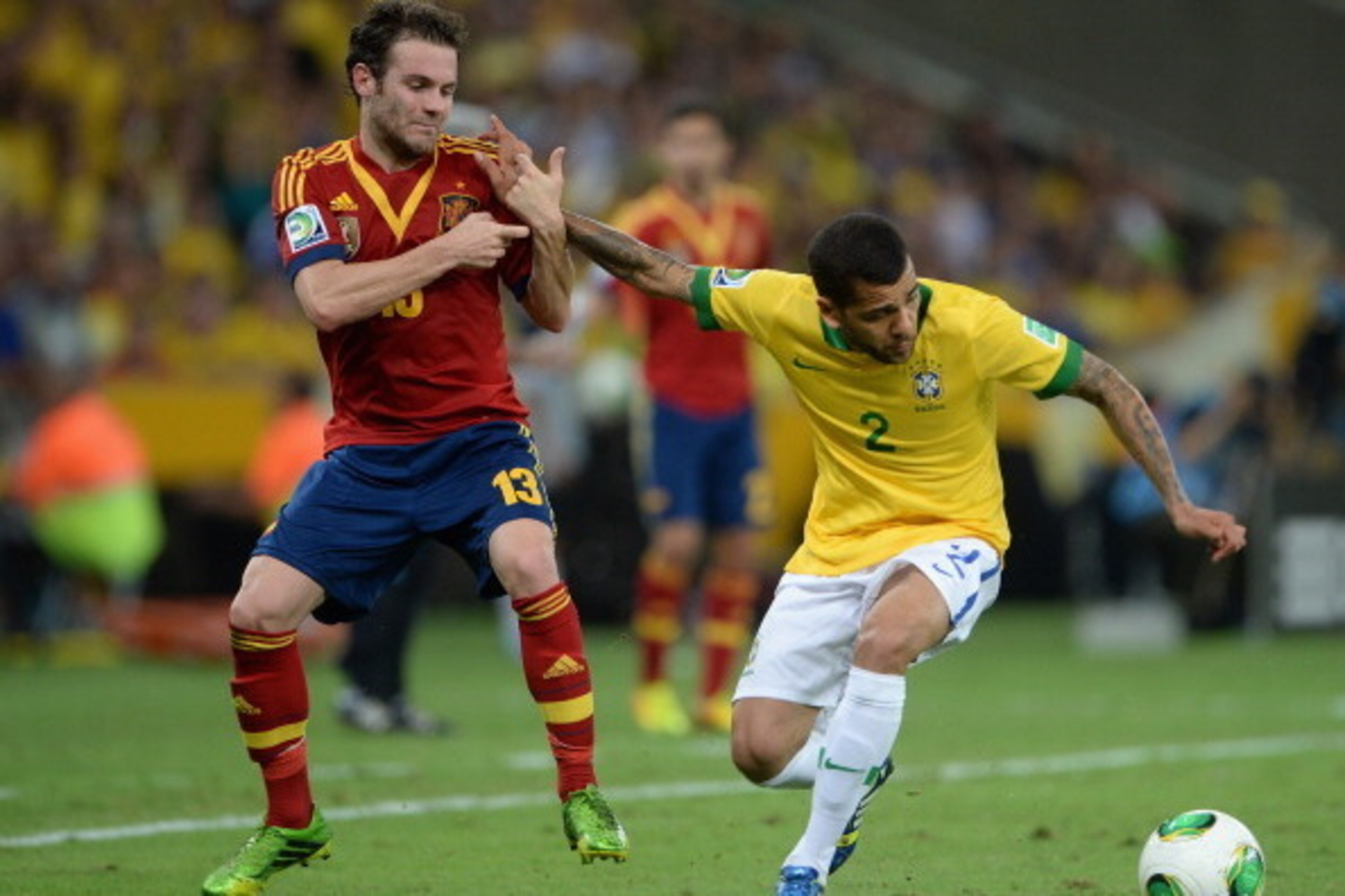 RIO DE JANEIRO, BRAZIL - JUNE 30: Juan Mata of Spain competes with Daniel Alves of Brazil during the FIFA Confederations Cup Brazil 2013 Final match between Brazil and Spain at Maracana on June 30, 2013 in Rio de Janeiro, Brazil. (Photo by Michael Regan RIO DE JANEIRO, BRAZIL - JUNE 30: Juan Mata of Spain competes with Daniel Alves of Brazil during the FIFA Confederations Cup Brazil 2013 Final match between Brazil and Spain at Maracana on June 30, 2013 in Rio de Janeiro, Brazil. (Photo by Michael Regan