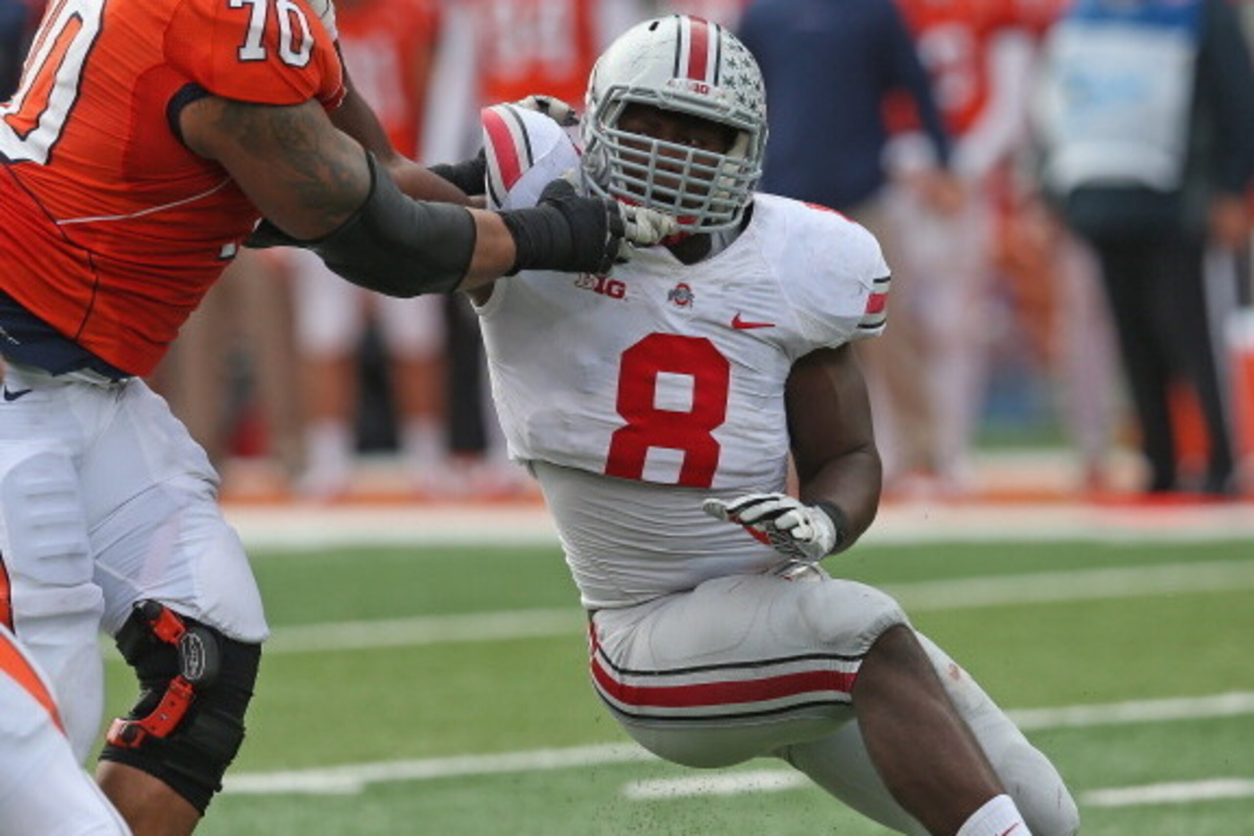CHAMPAIGN, IL - NOVEMBER 16:  Noah Spence #8 of the Ohio State Buckeyes rushes against Corey lewis #70 of the Illinois Fighting Illini at Memorial Stadium on November 16, 2013 in Champaign, Illinois. Ohio State defeated Illinois 60-35.  (Photo by Jonathan