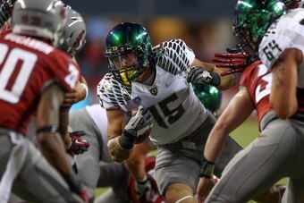 SEATTLE, WA - SEPTEMBER 29:  Tight end Colt Lyerla #15 of the Oregon Ducks rushes against the Washington State Cougars on September 29, 2012 at CenturyLink Field in Seattle, Washington.  (Photo by Otto Greule Jr/Getty Images)