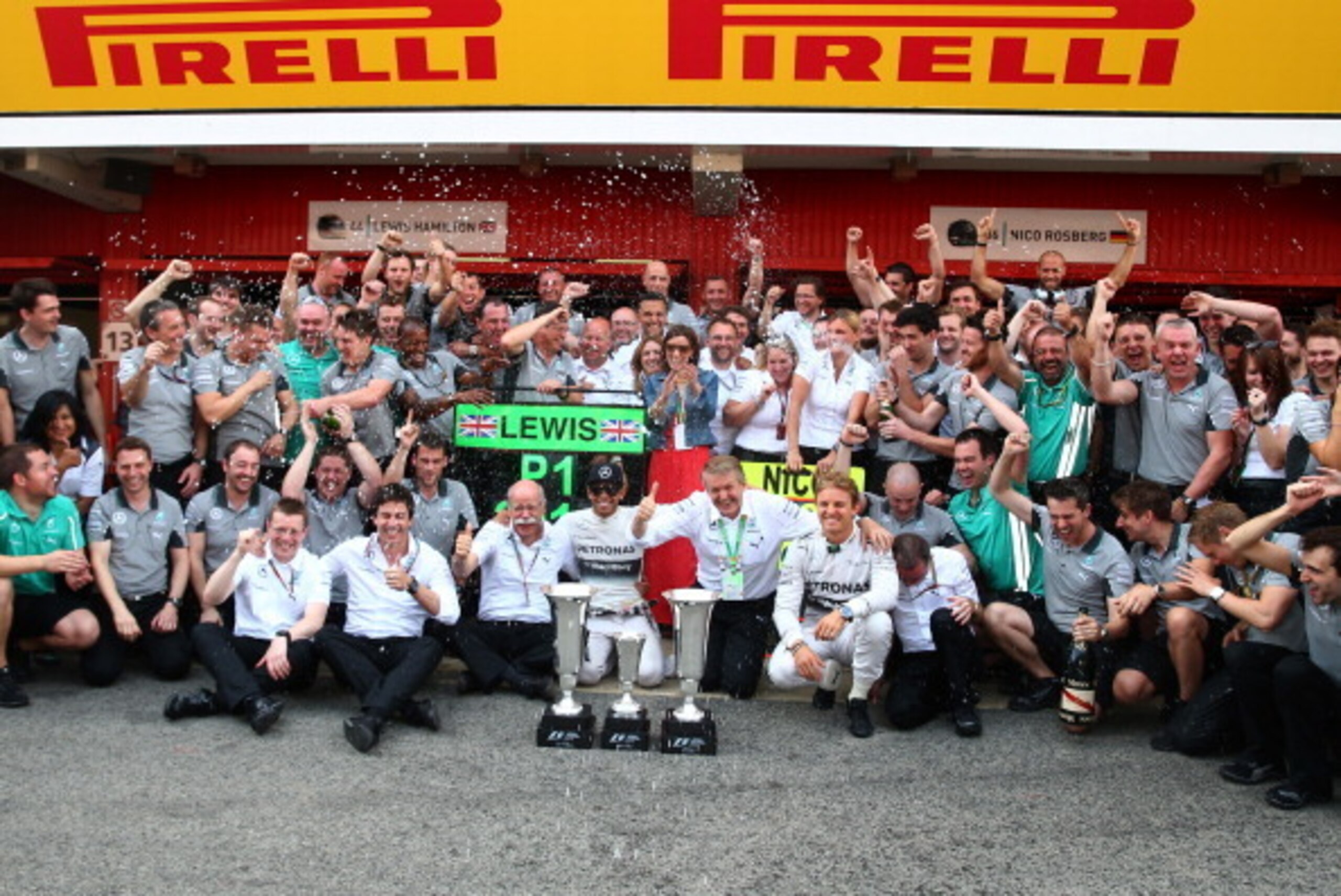 MONTMELO, SPAIN - MAY 11:  Lewis Hamilton of Great Britain and Mercedes GP celebrates his victory with Nico Rosberg of Germany and Mercedes GP and the rest of the Mercedes team after the Spanish Formula One Grand Prix at Circuit de Catalunya on May 11, 20