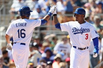 GLENDALE, AZ - MARCH 10:  Carl Crawford #3 of the Los Angeles Dodgers high fives Andre Ethier #16 after Ethier hit a three run home-run against the Oakland Athletics during the first inning of the spring training game at Camelback Ranch on March 10, 2014 