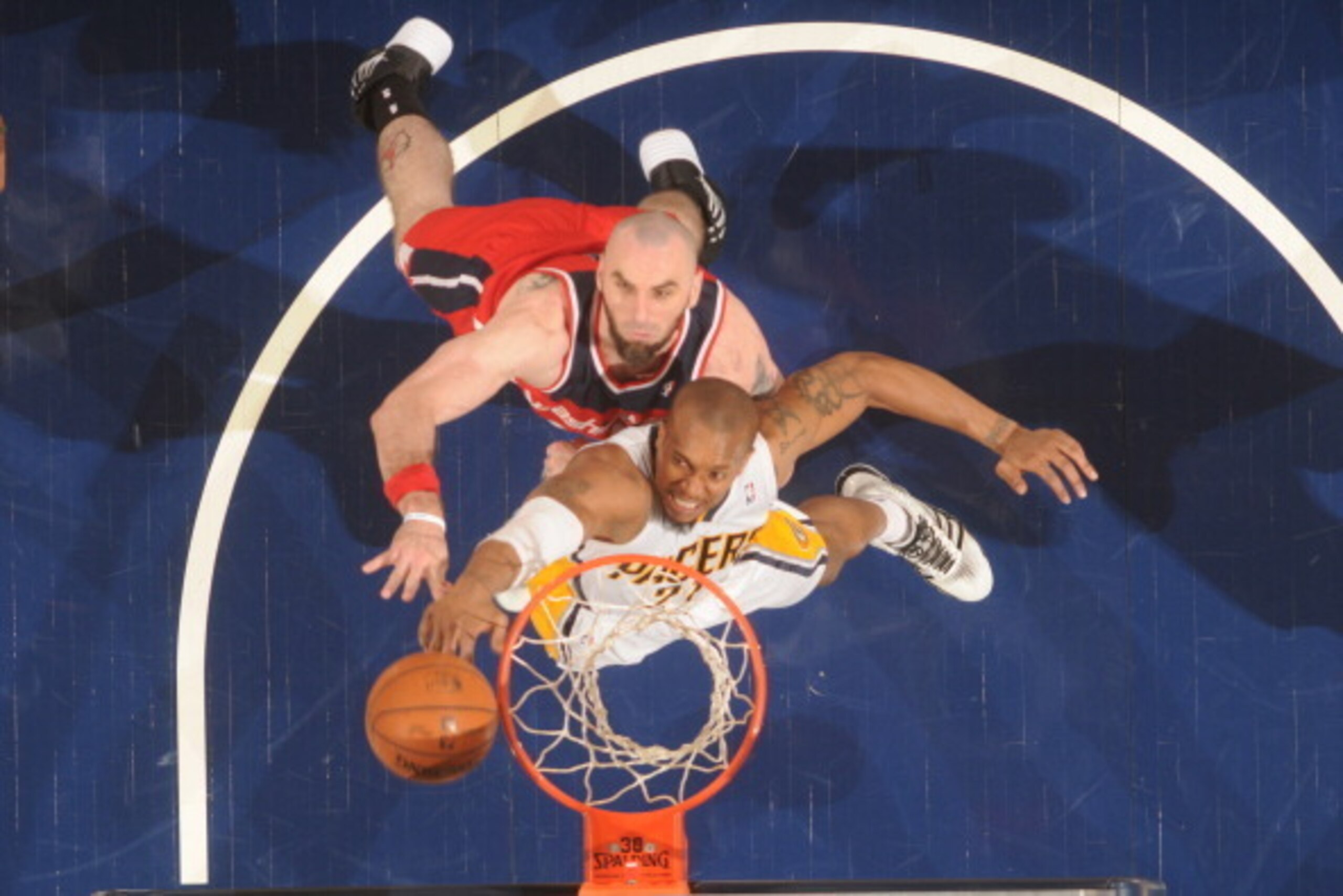 INDIANAPOLIS, IND - MAY 13: David West #21 of the Indiana Pacers rebounds against Marcin Gortat #4 of the Washington Wizards in Game Five of the Eastern Conference Semi-Finals during the 2014 NBA Plaoffs at Bankers Life Fieldhouse on May 13, 2014 in India
