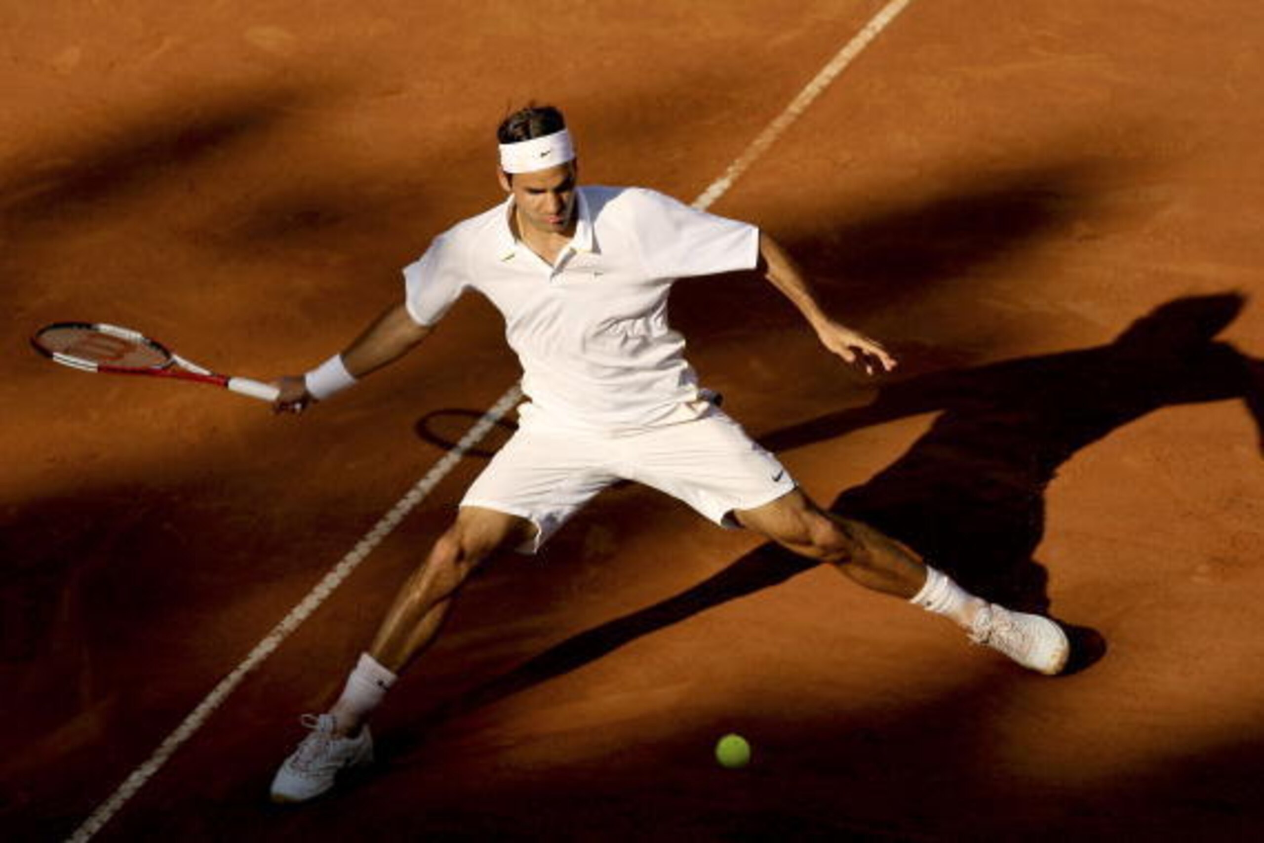 ROME - MAY 14:  Roger Federer of Switzerland plays a forehand against Rafael Nadal of Spain in the final of the ATP Masters Series on May 14, 2006 at the Foro Italico in Rome, Italy.  (Photo by Clive Brunskill/Getty Images)