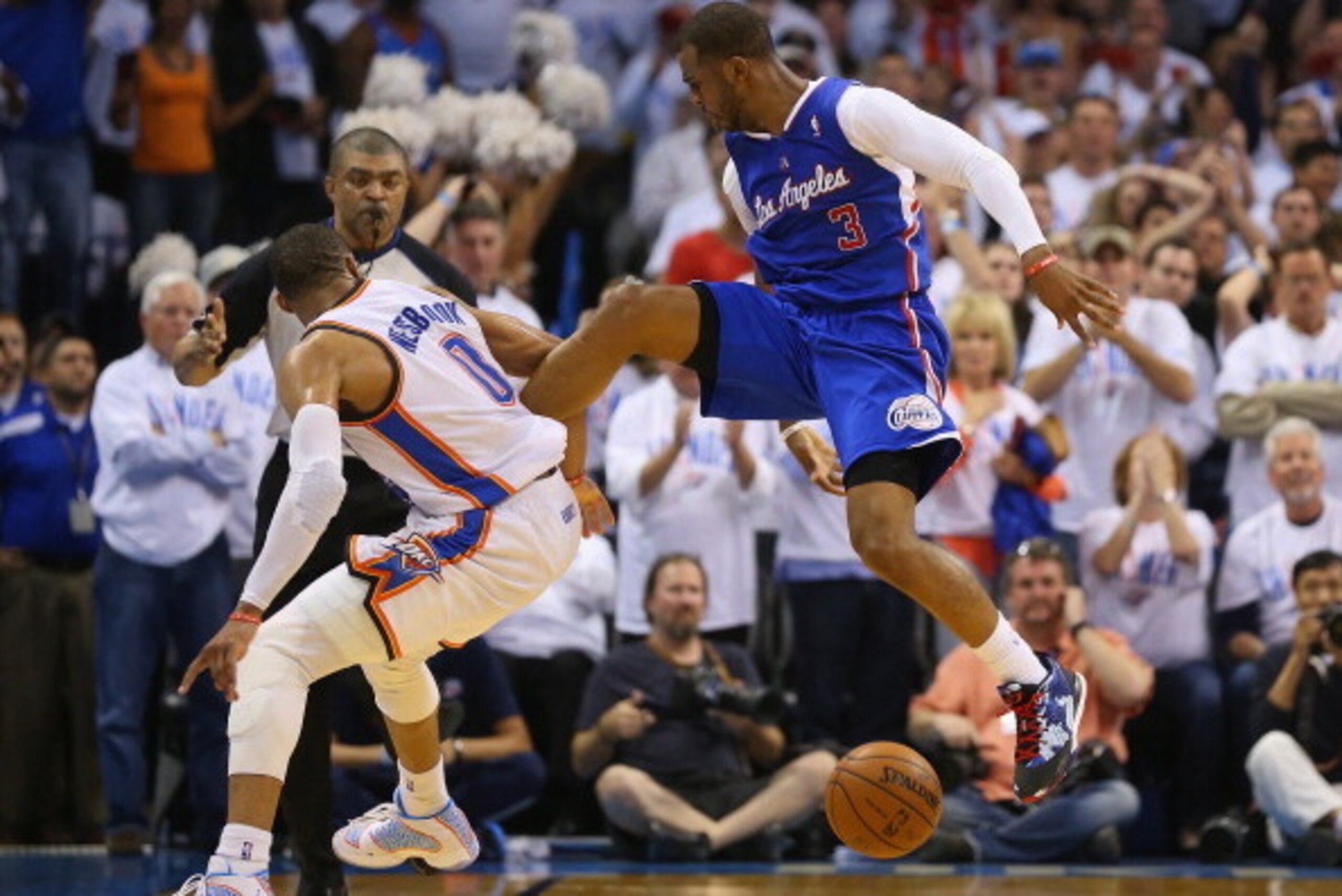 OKLAHOMA CITY, OK - MAY 13: Chris Paul #3 of the Los Angeles Clippers loses control of the ball in front of Russell Westbrook #0 of the Oklahoma City Thunder in Game Five of the Western Conference Semifinals during the 2014 NBA Playoffs at Chesapeake Ene OKLAHOMA CITY, OK - MAY 13: Chris Paul #3 of the Los Angeles Clippers loses control of the ball in front of Russell Westbrook #0 of the Oklahoma City Thunder in Game Five of the Western Conference Semifinals during the 2014 NBA Playoffs at Chesapeake Ene