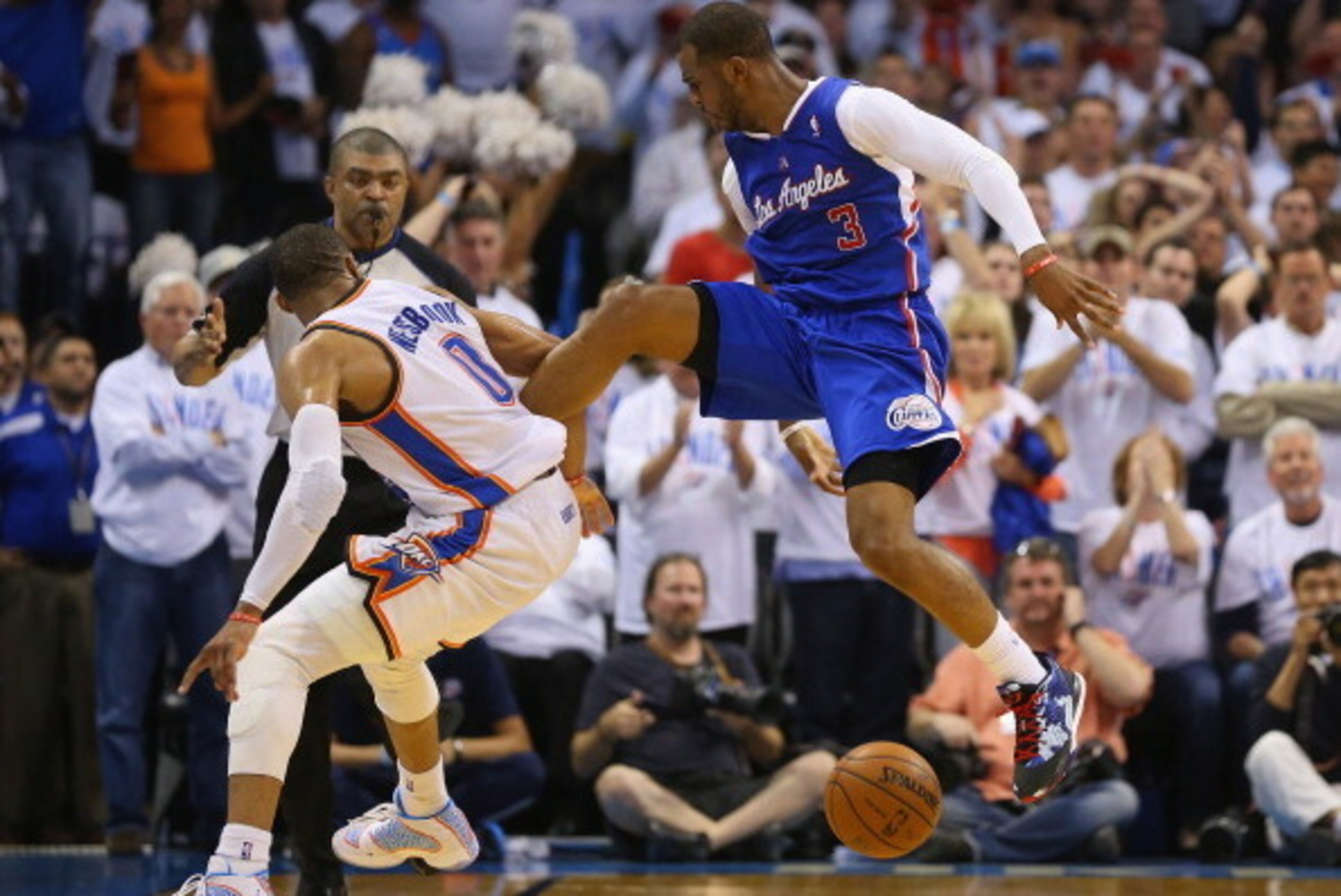 OKLAHOMA CITY, OK - MAY 13: Chris Paul #3 of the Los Angeles Clippers loses control of the ball in front of Russell Westbrook #0 of the Oklahoma City Thunder in Game Five of the Western Conference Semifinals during the 2014 NBA Playoffs at Chesapeake Ene OKLAHOMA CITY, OK - MAY 13: Chris Paul #3 of the Los Angeles Clippers loses control of the ball in front of Russell Westbrook #0 of the Oklahoma City Thunder in Game Five of the Western Conference Semifinals during the 2014 NBA Playoffs at Chesapeake Ene