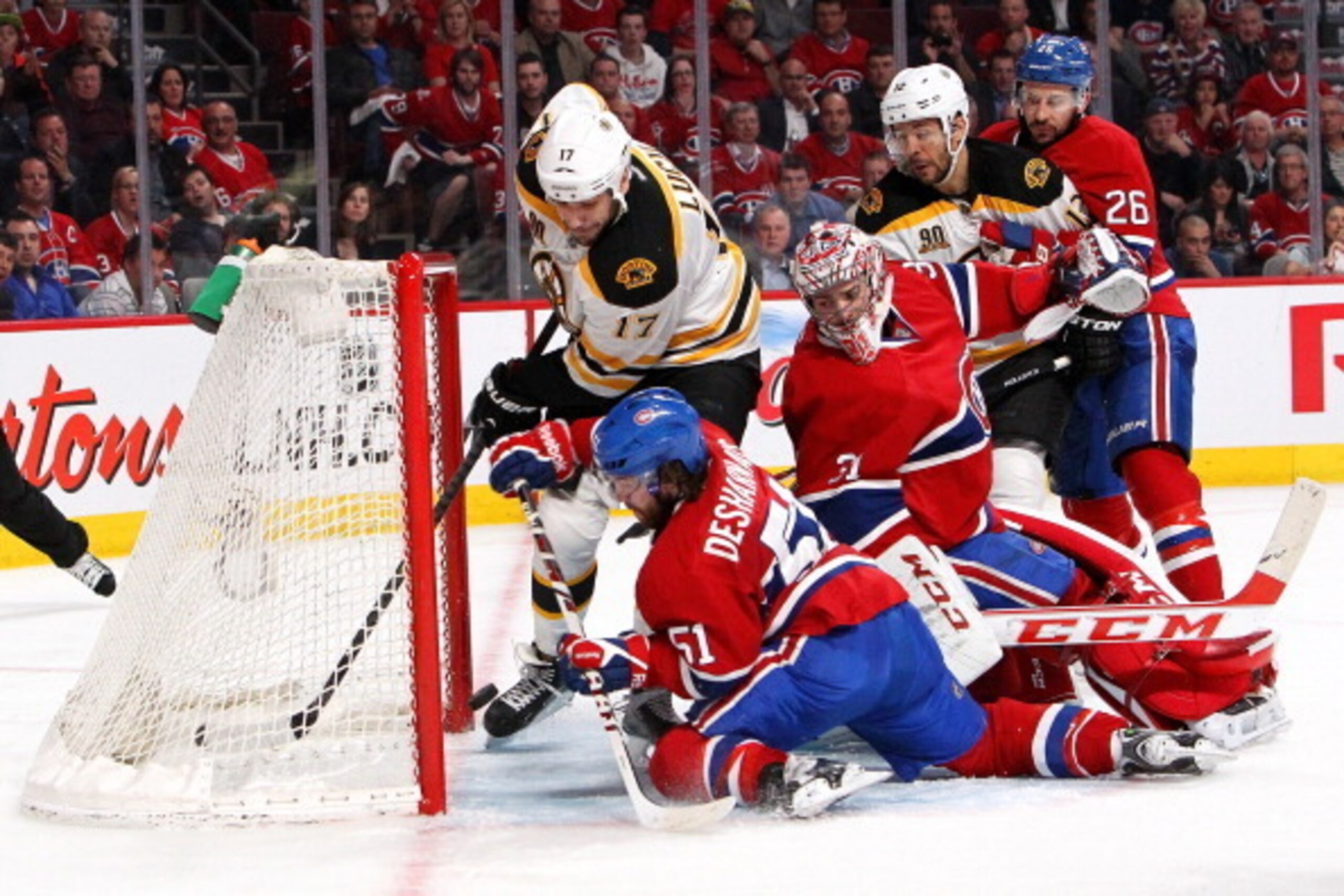 MONTREAL, QC - MAY 12:  Milan Lucic #17 and Jarome Iginla #12 of the Boston Bruins battle for a loose puck against goalie Carey Price #31, Josh Gorges #26 and David Desharnais #51 of the Montreal Canadiens in Game Six of the Second Round of the 2014 NHL S