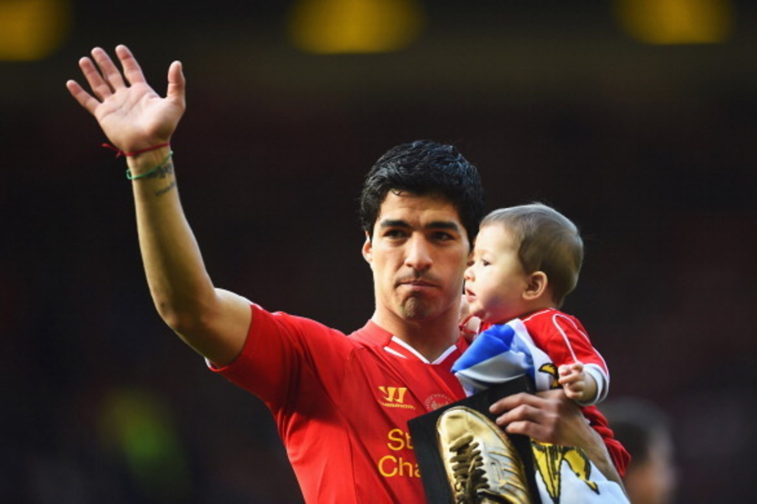 LIVERPOOL, ENGLAND - MAY 11:  Luis Suarez of Liverpool with his son Benjamin after the Barclays Premier League match between Liverpool and Newcastle United at Anfield on May 11, 2014 in Liverpool, England. Liverpool finish as runners-up in the Premier Lea