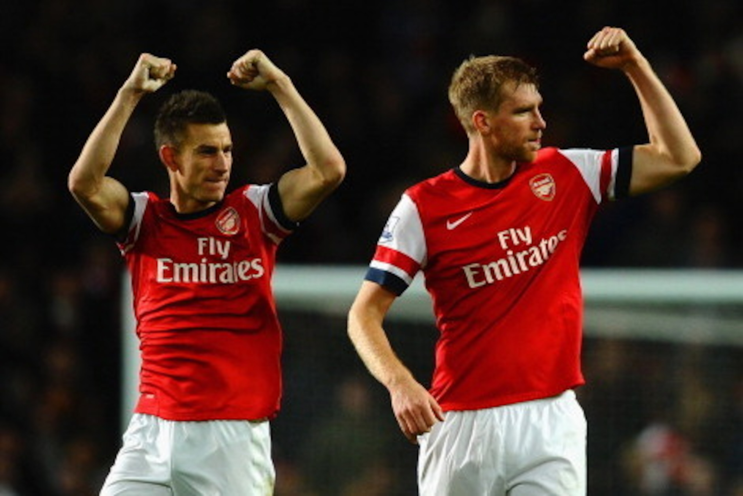 LONDON, ENGLAND - NOVEMBER 02: Laurent Koscielny of Arsenal and Per Mertesacker of Arsenal celebrate victory at the final whistle during the Barclays Premier League match between Arsenal and Liverpool at Emirates Stadium on November 2, 2013 in London, En LONDON, ENGLAND - NOVEMBER 02: Laurent Koscielny of Arsenal and Per Mertesacker of Arsenal celebrate victory at the final whistle during the Barclays Premier League match between Arsenal and Liverpool at Emirates Stadium on November 2, 2013 in London, En