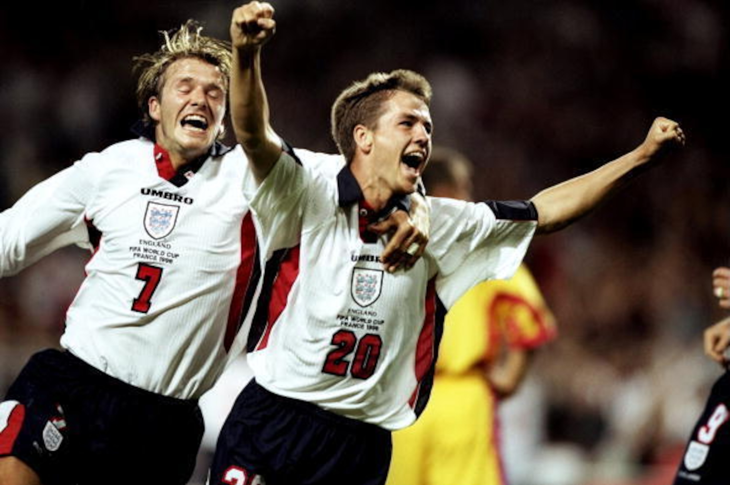 22 Jun 1998:  Michael Owen of England celebrates with team mate David Beckham after scoring in the World Cup group G game against Romania at the Stade Municipal in Toulouse, France. England lost 2-1. \ Mandatory Credit: Ben Radford /Allsport