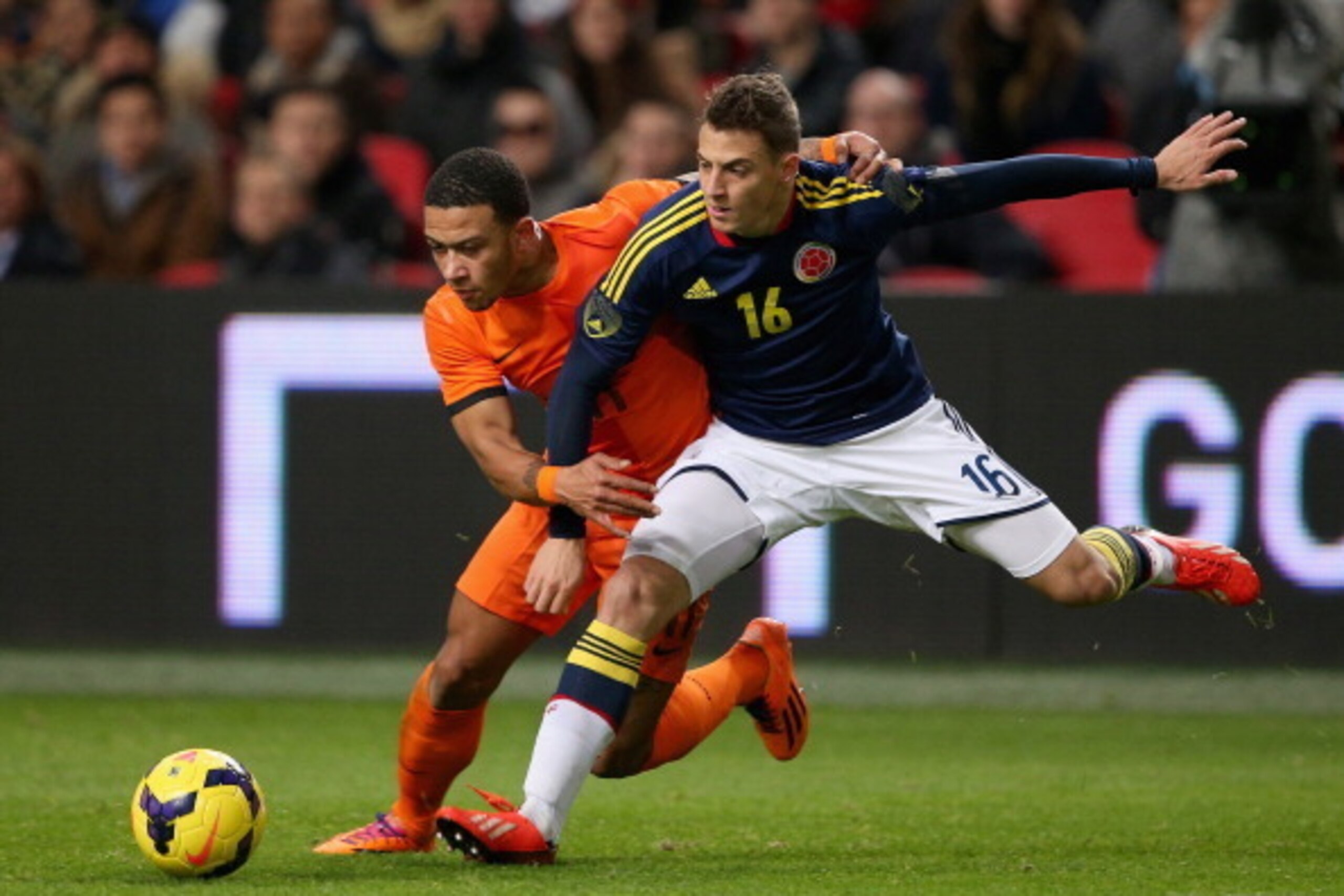 AMSTERDAM, NETHERLANDS - NOVEMBER 19: Memphis Depay of Netherlands in action with Santiago Arias of Columbia during the friendly International match between the Netherlands and Columbia at the Amsterdam Arena on November 19, 2013 in Amsterdam, Netherland AMSTERDAM, NETHERLANDS - NOVEMBER 19: Memphis Depay of Netherlands in action with Santiago Arias of Columbia during the friendly International match between the Netherlands and Columbia at the Amsterdam Arena on November 19, 2013 in Amsterdam, Netherland