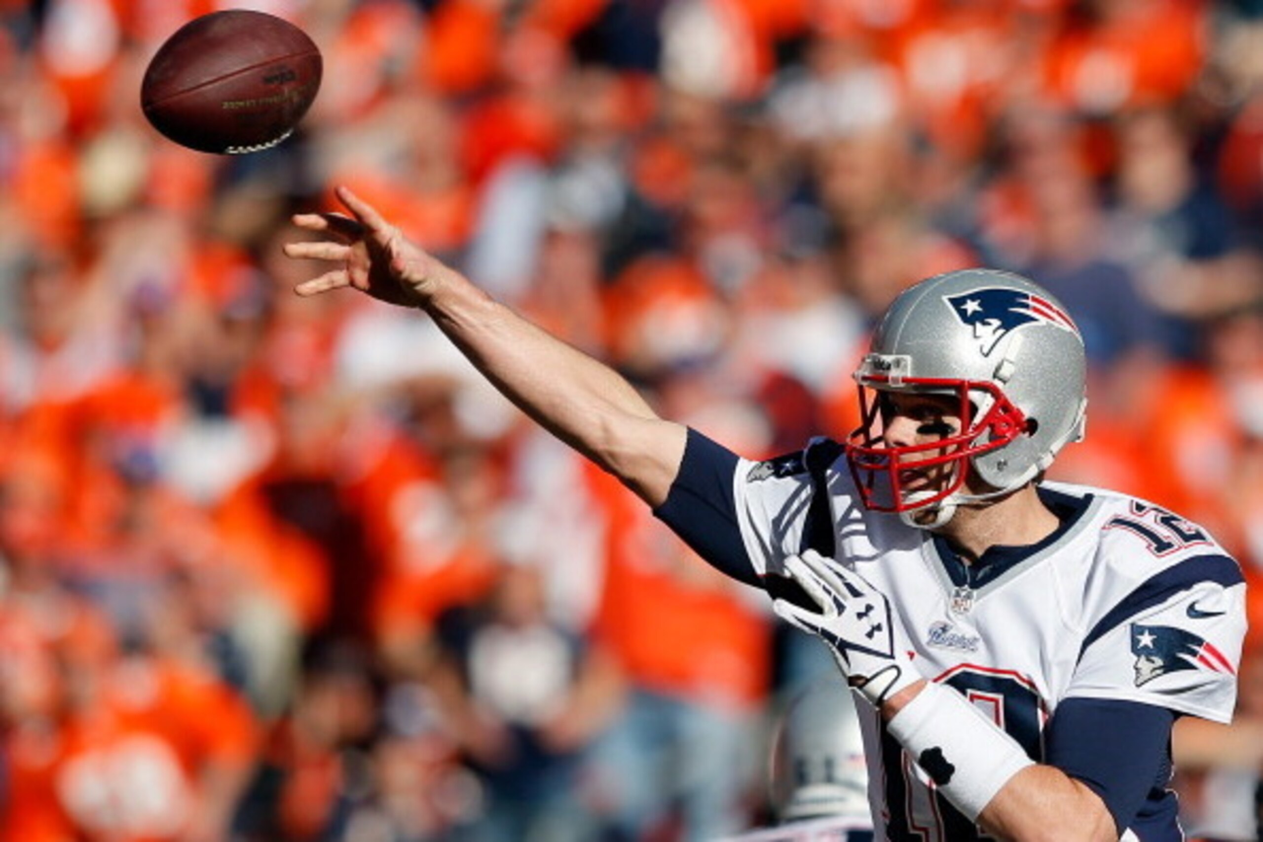 DENVER, CO - JANUARY 19:   Tom Brady #12 of the New England Patriots throws a pass against the Denver Broncos during the AFC Championship game at Sports Authority Field at Mile High on January 19, 2014 in Denver, Colorado.  (Photo by Kevin C. Cox/Getty Im
